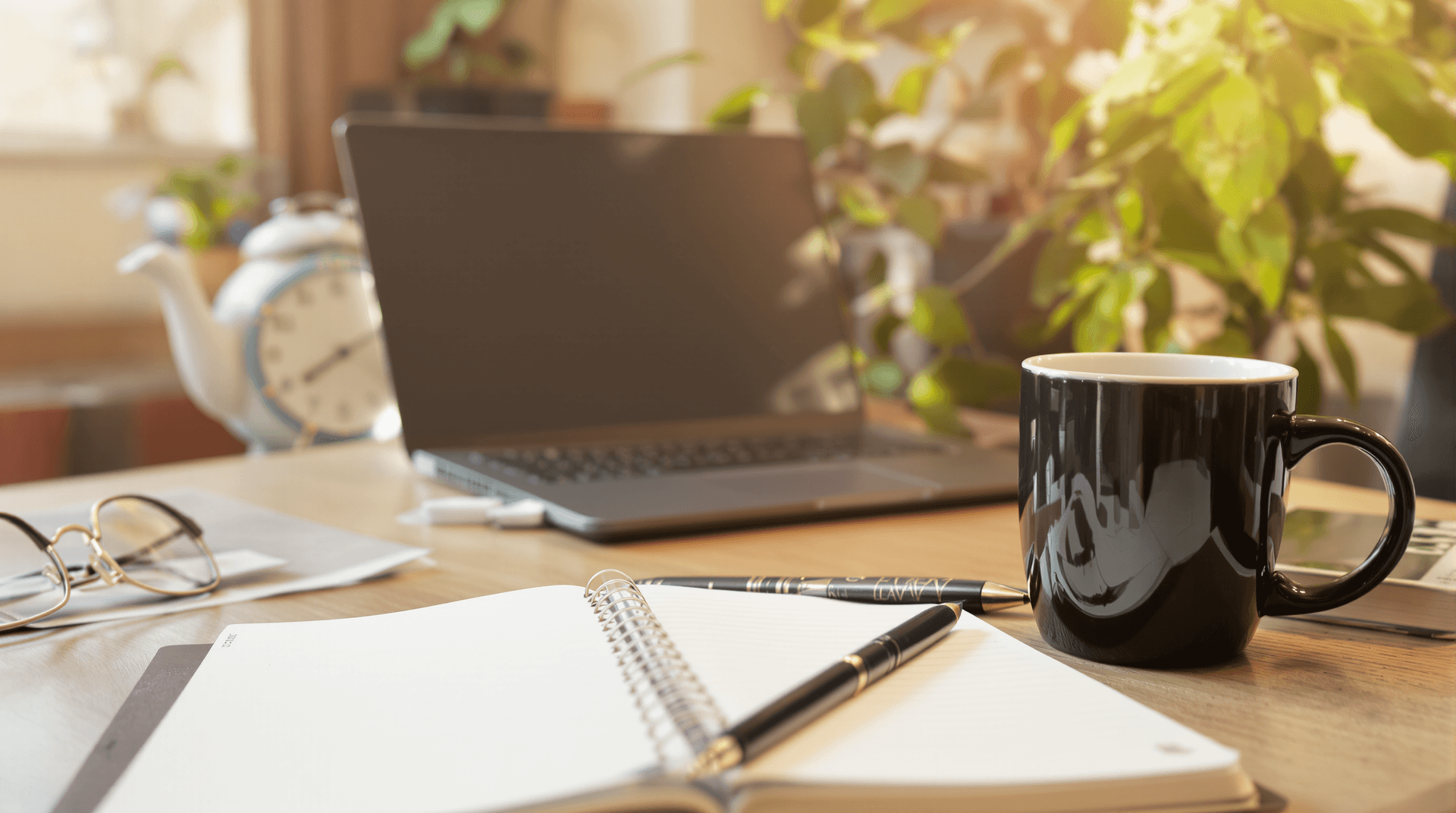 AI generated: A cozy home office setup with a laptop, notebook, and coffee mug on a wooden desk, a plant in the ba...