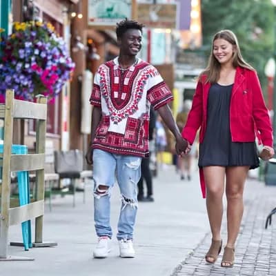 AI generated video: The camera moves back as the couple walks slowly towards it