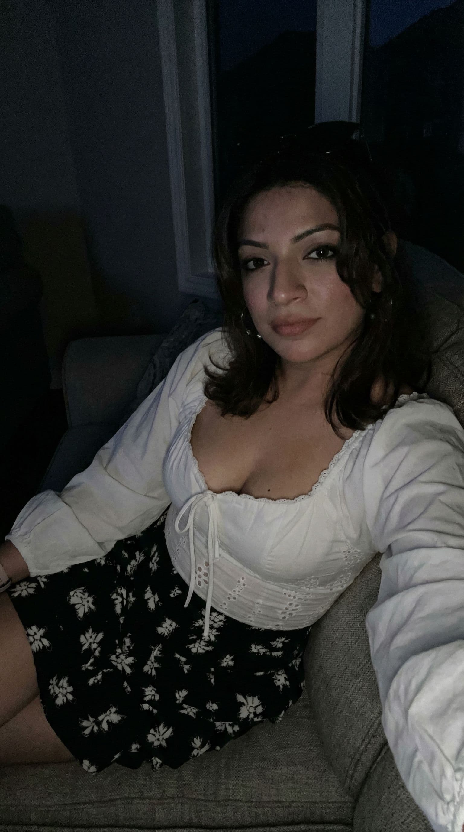 AI generated: Wearing same clothes, sitting on a couch, close view, 35-year-old indian woman, busty body, at night...