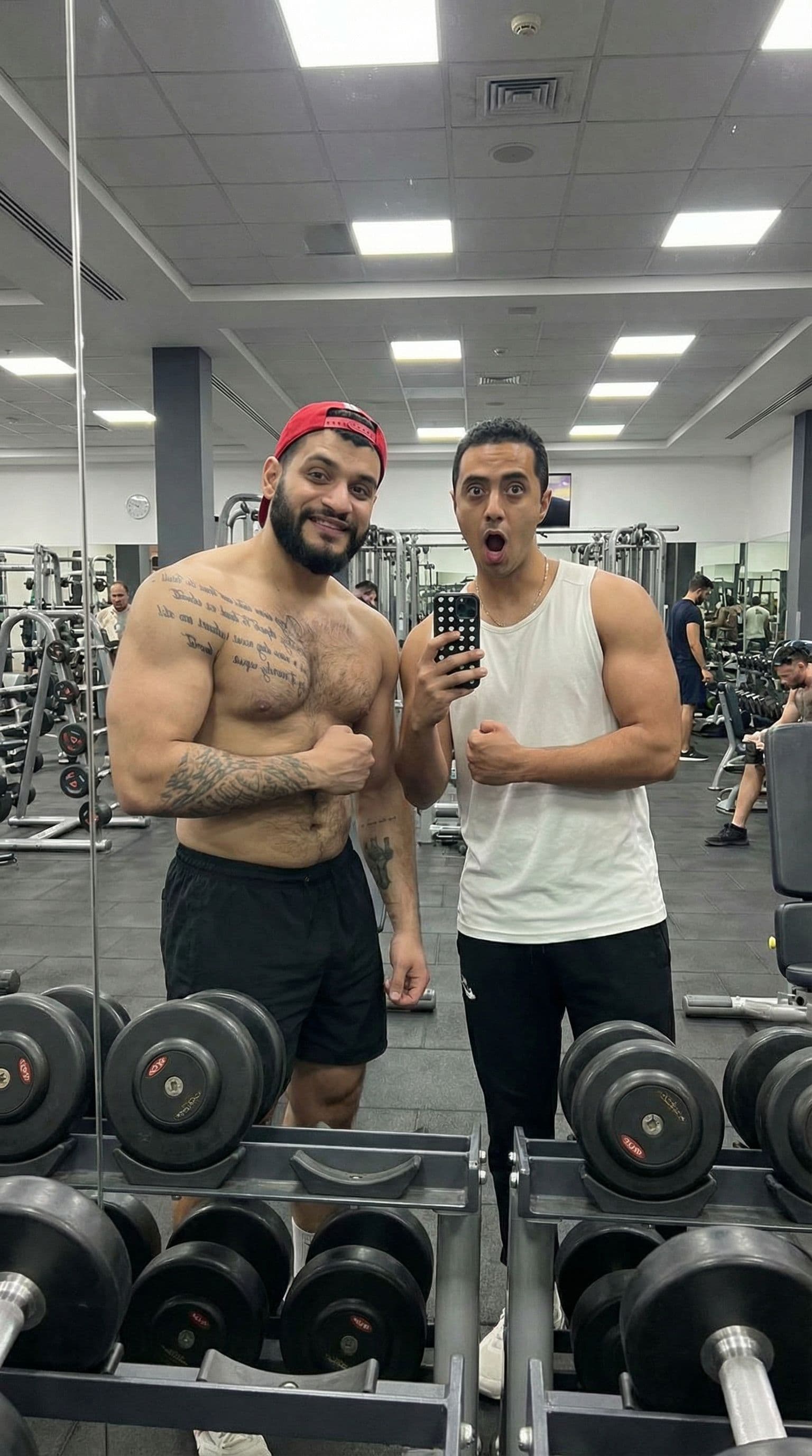 AI generated: Merge us in one picture, Make us take a photo in a gym mirror, tattoo person make little bite bulky ...