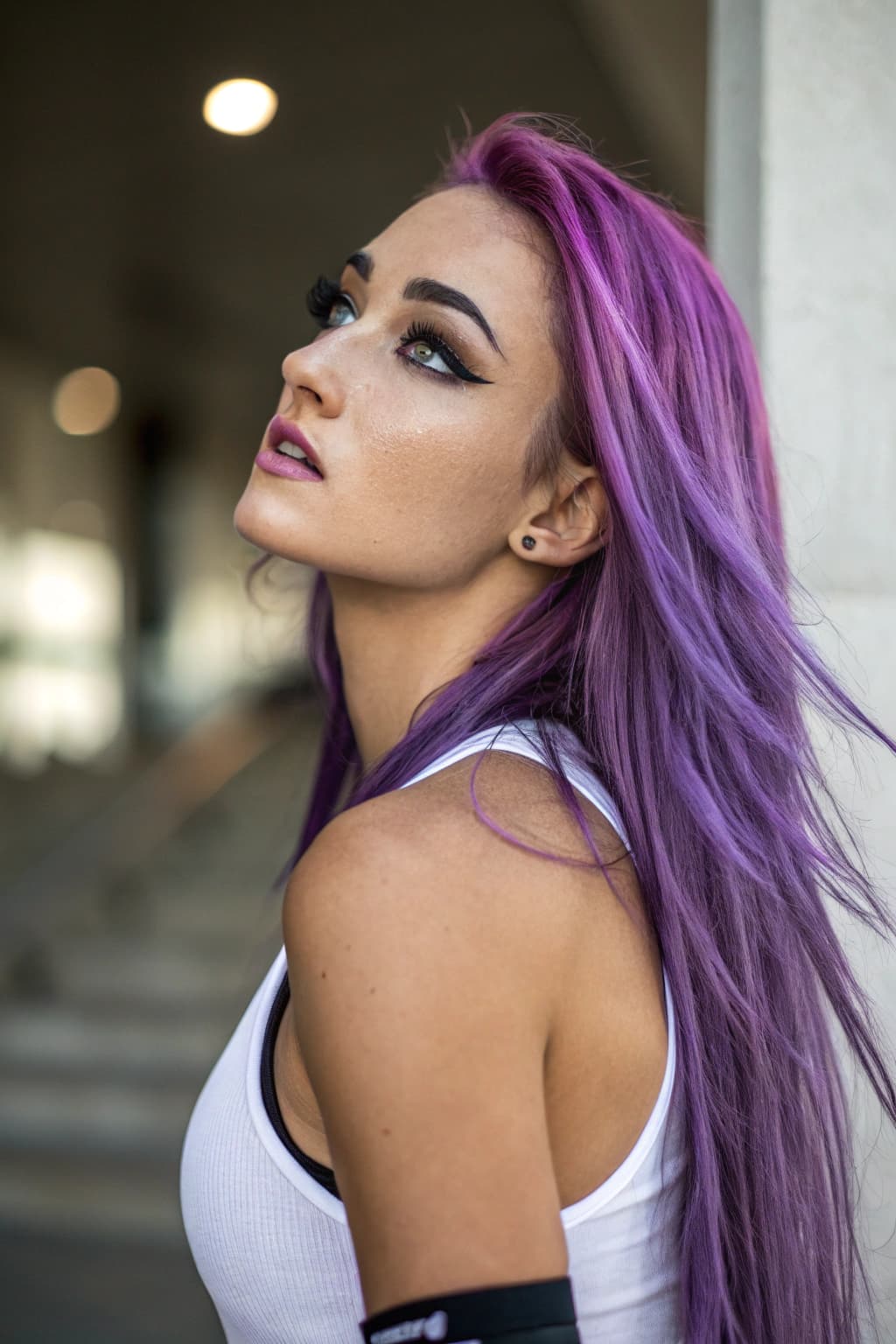 AI generated: A stunning young woman with striking, unique features. She has long, flowing purple hair cascading o...
