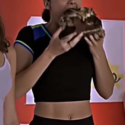 AI generated video: Slow motion, detailed, eyes wide, stuffing a large piece of chocolate cake in her mouth, messy