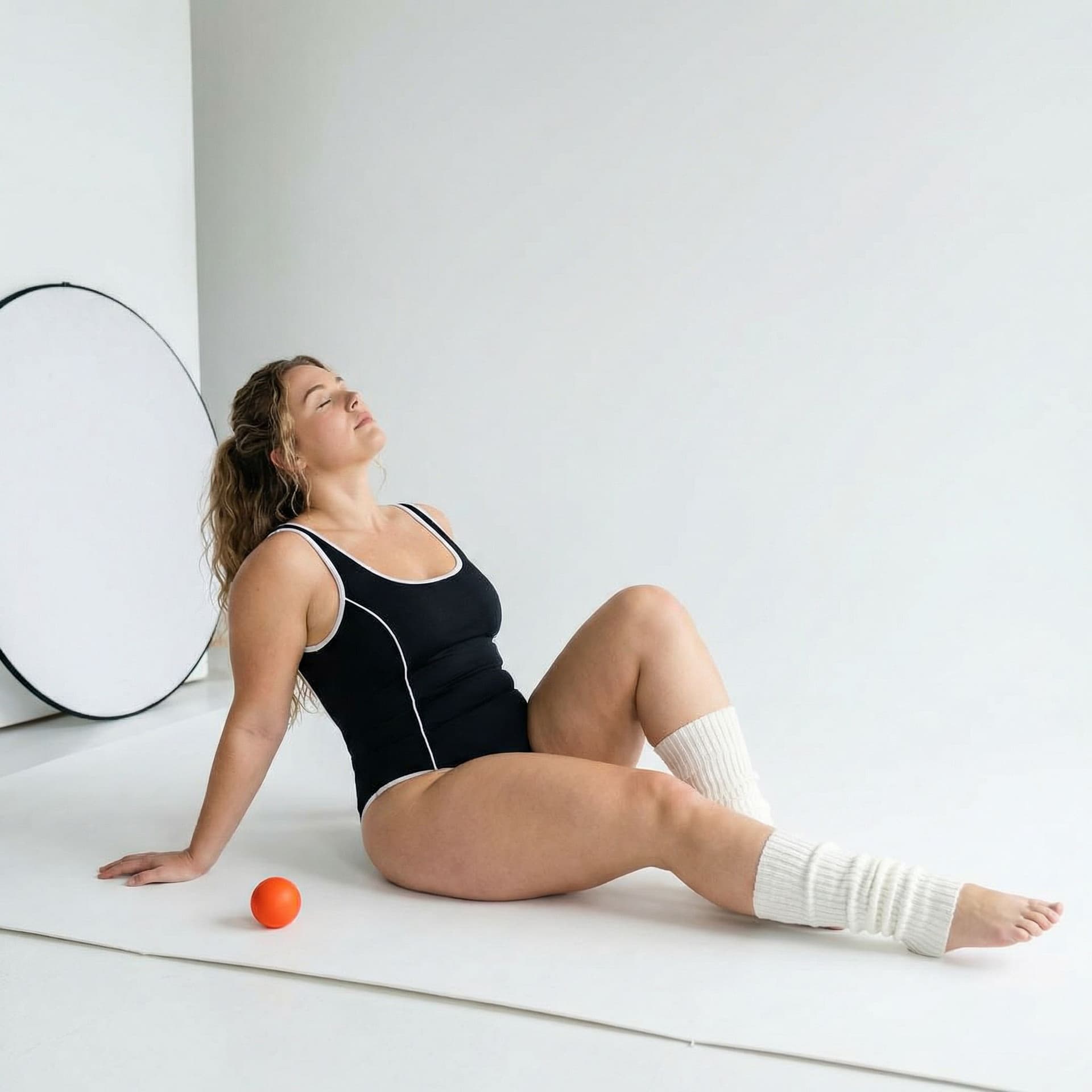 AI generated: A Stunning Muscular Curvy woman with long, light brown hair is posing in a minimalist studio setting...