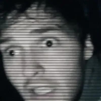 AI generated video: A handheld found-footage horror video at night in a dark forest, filmed with a shaky old camcorder. ...