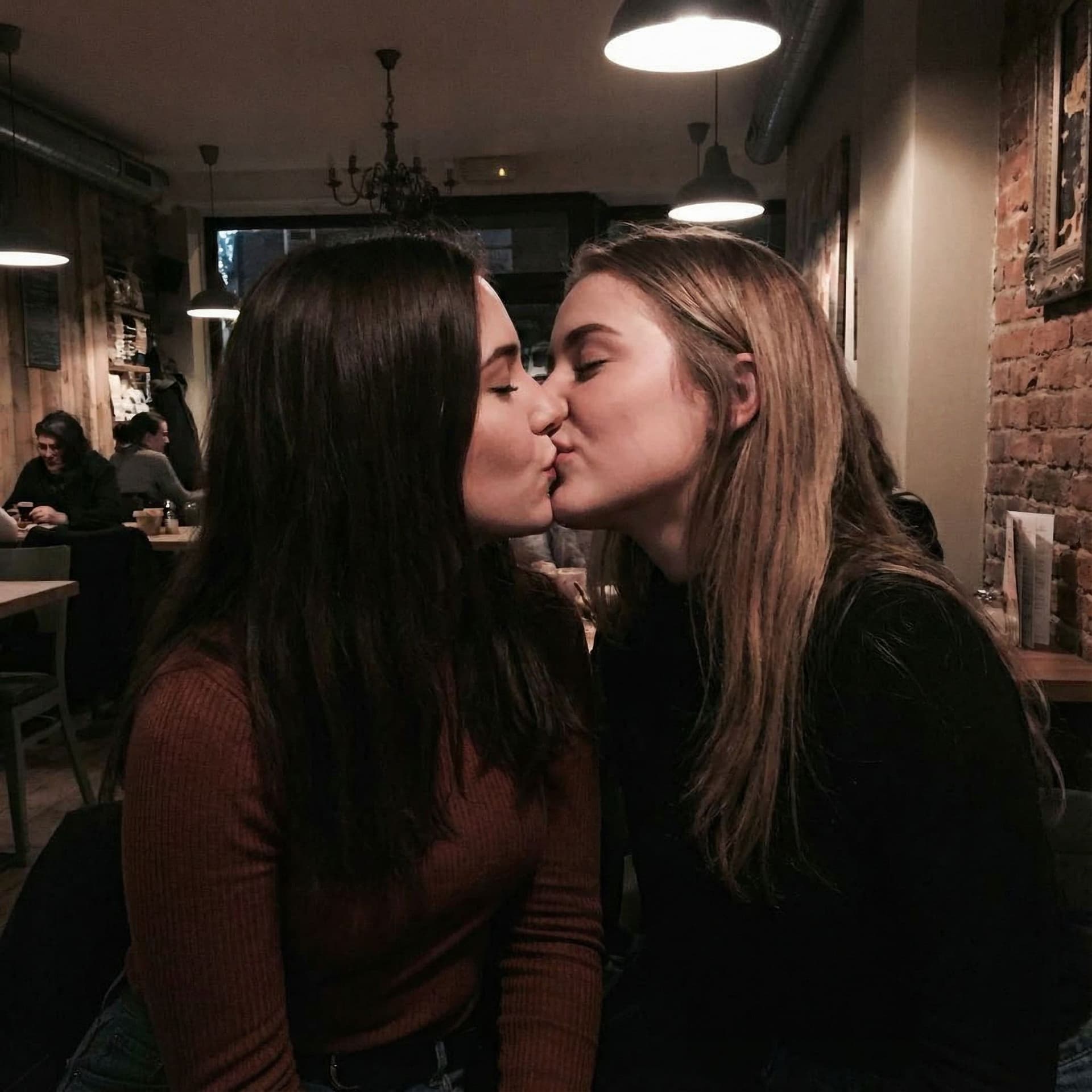 AI generated: With the image uploaded make the two girls passionately kissing with tongue