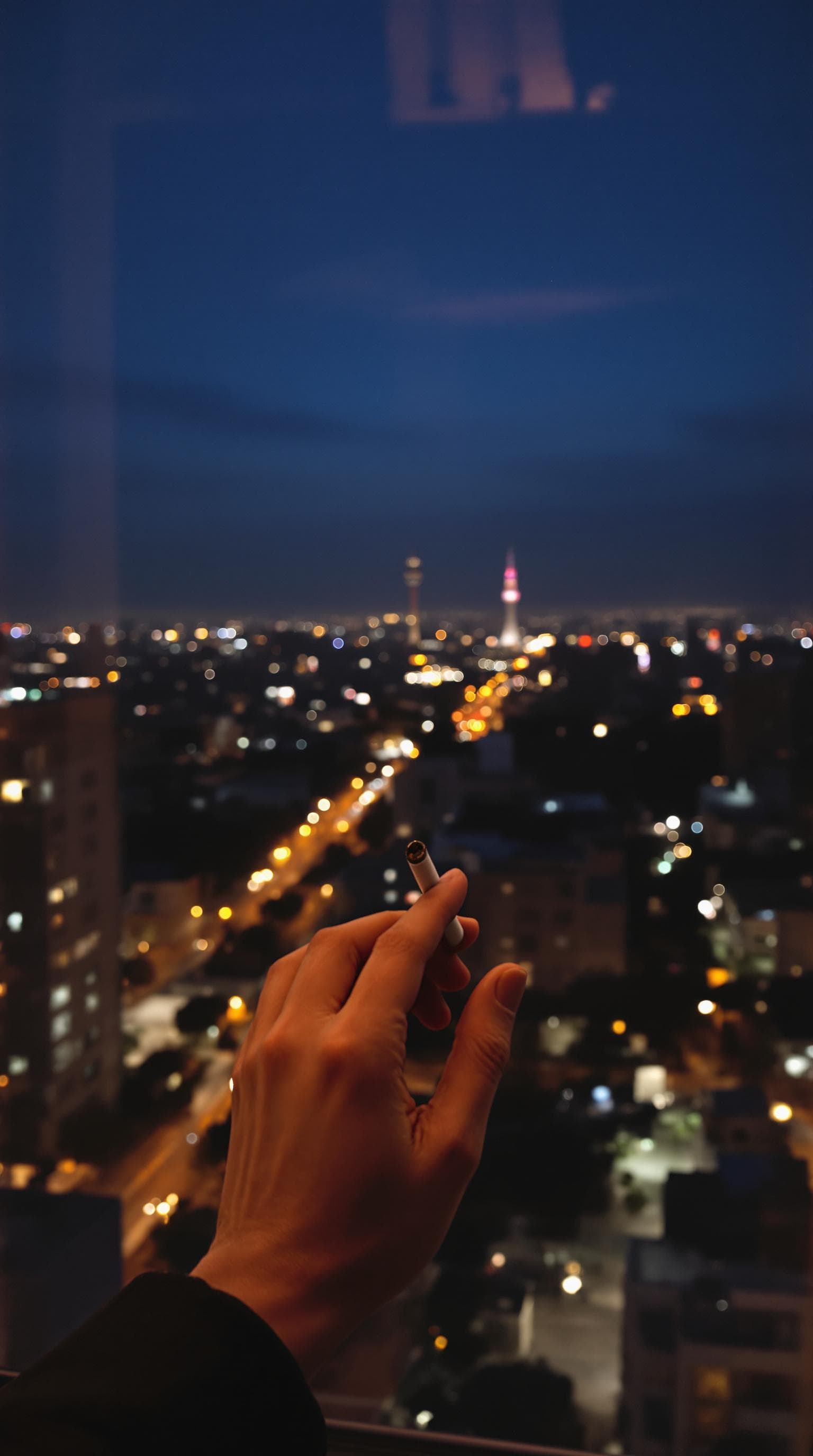AI generated: POV first-person, i am standing by the window, smoking professionally  a cigarette, captured from a ...