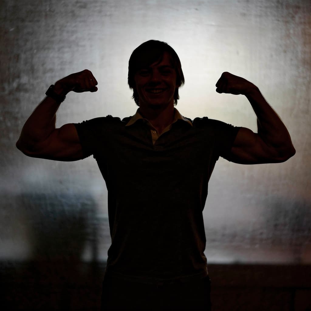 AI generated: muscular twink smiling while flexing huge muscles.blackhe is naked