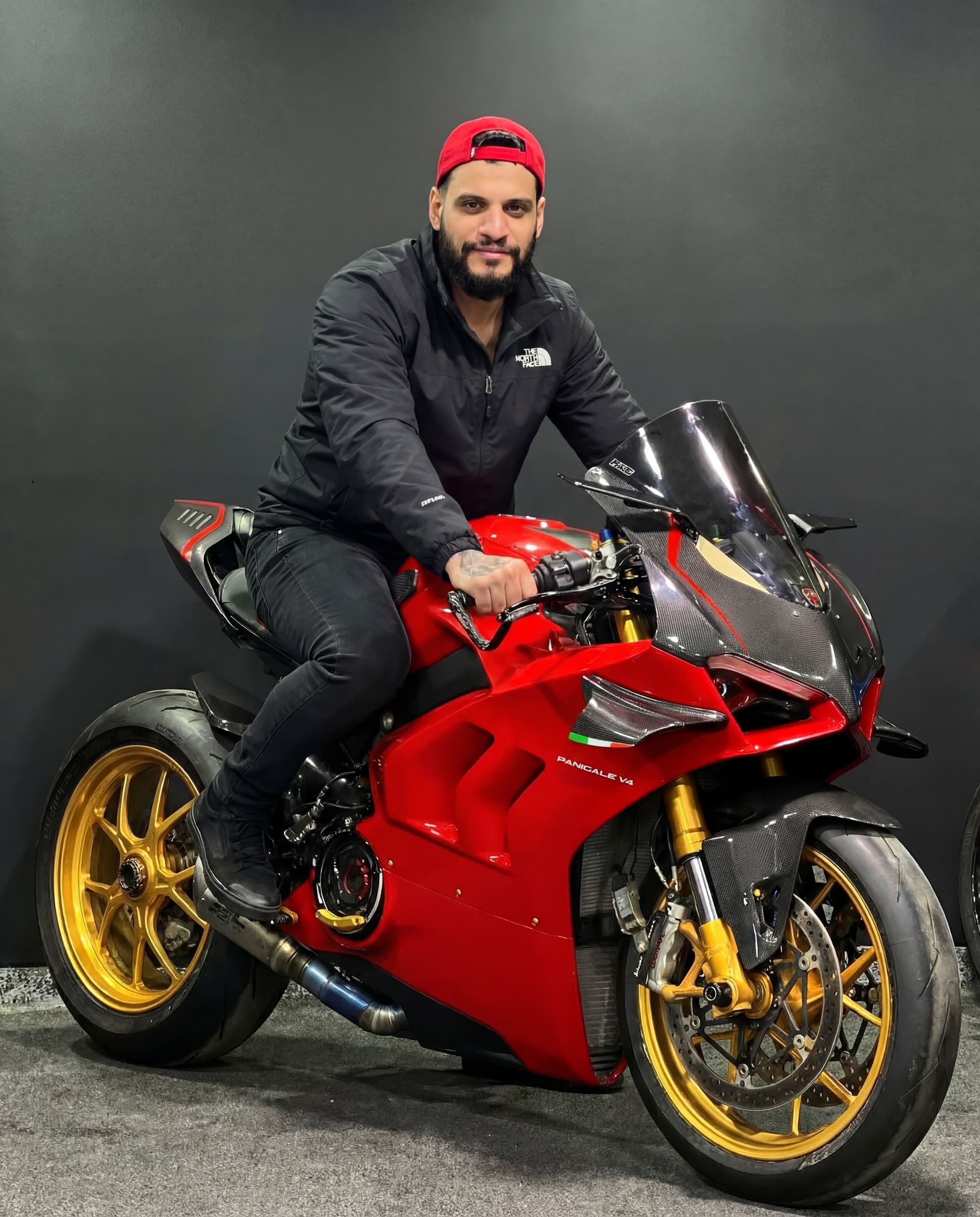 AI generated: Added that guy on this bike wearing black Northface jacket, black jeans, black shoes, same face feat...