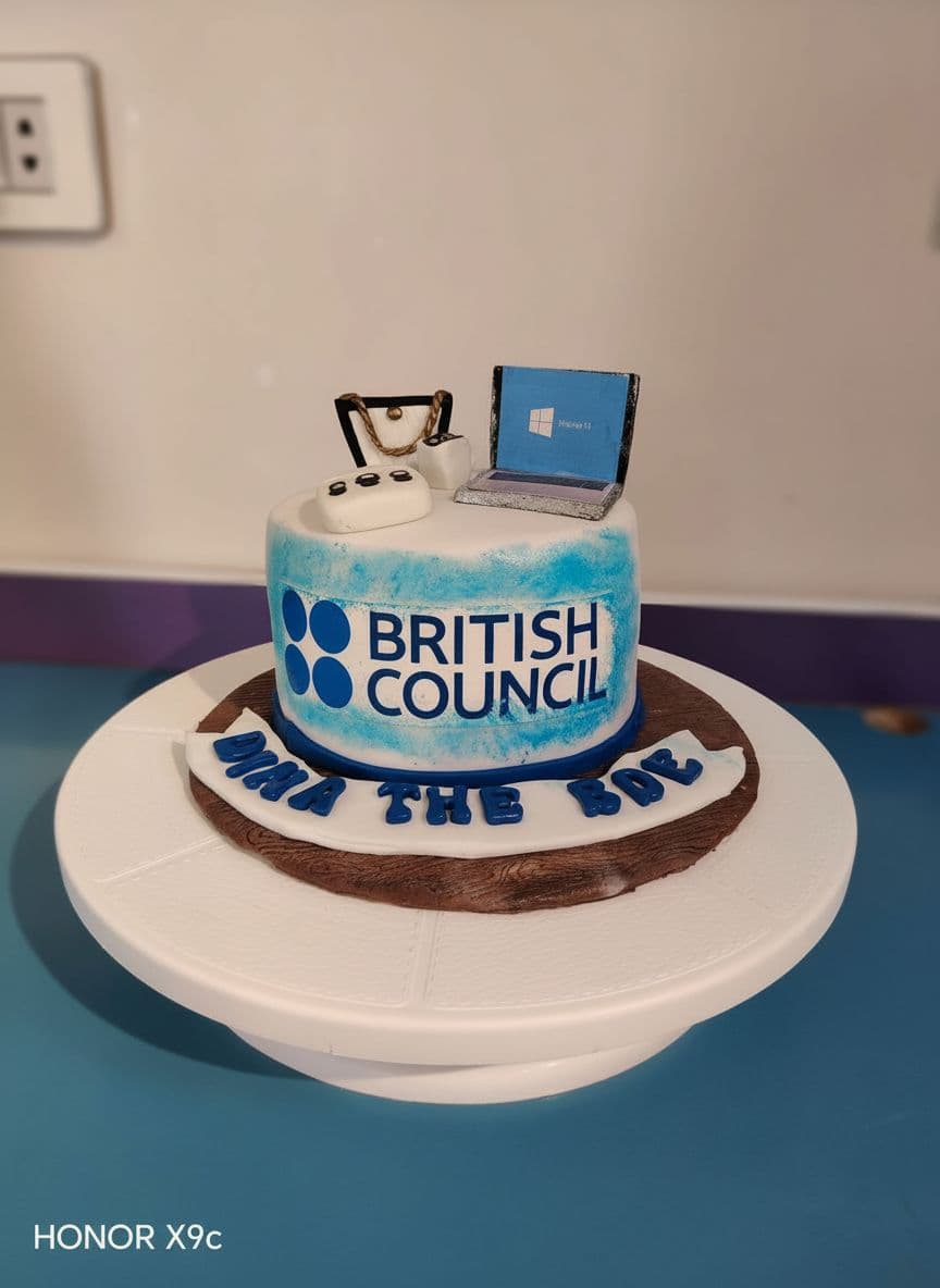 AI generated: High-quality food photo of a fondant cake with British Council logo, corrected colors, clean edges, ...