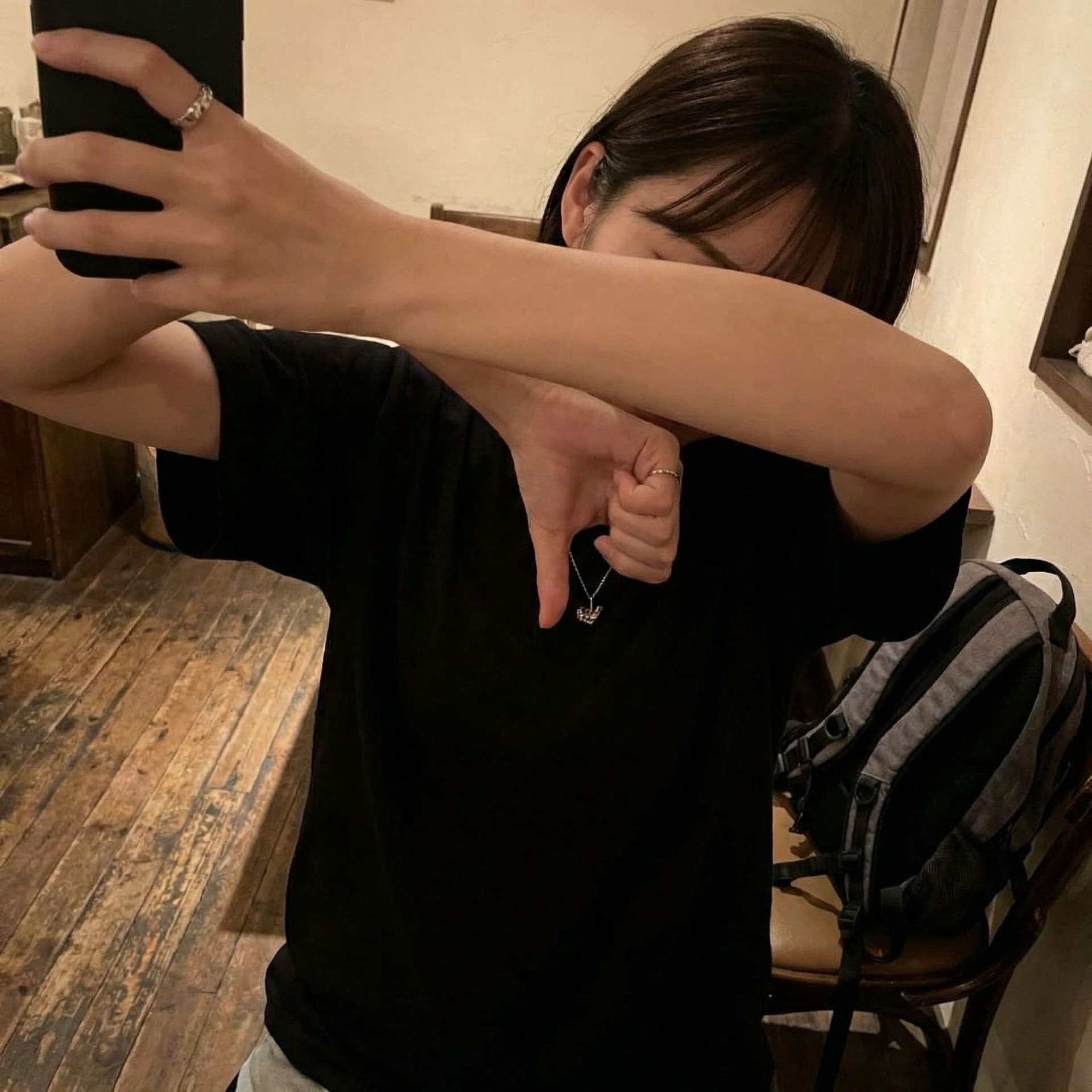 AI generated: A photorealistic image of a 26-year-old woman with fair skin wearing a black t-shirt. She is taking ...