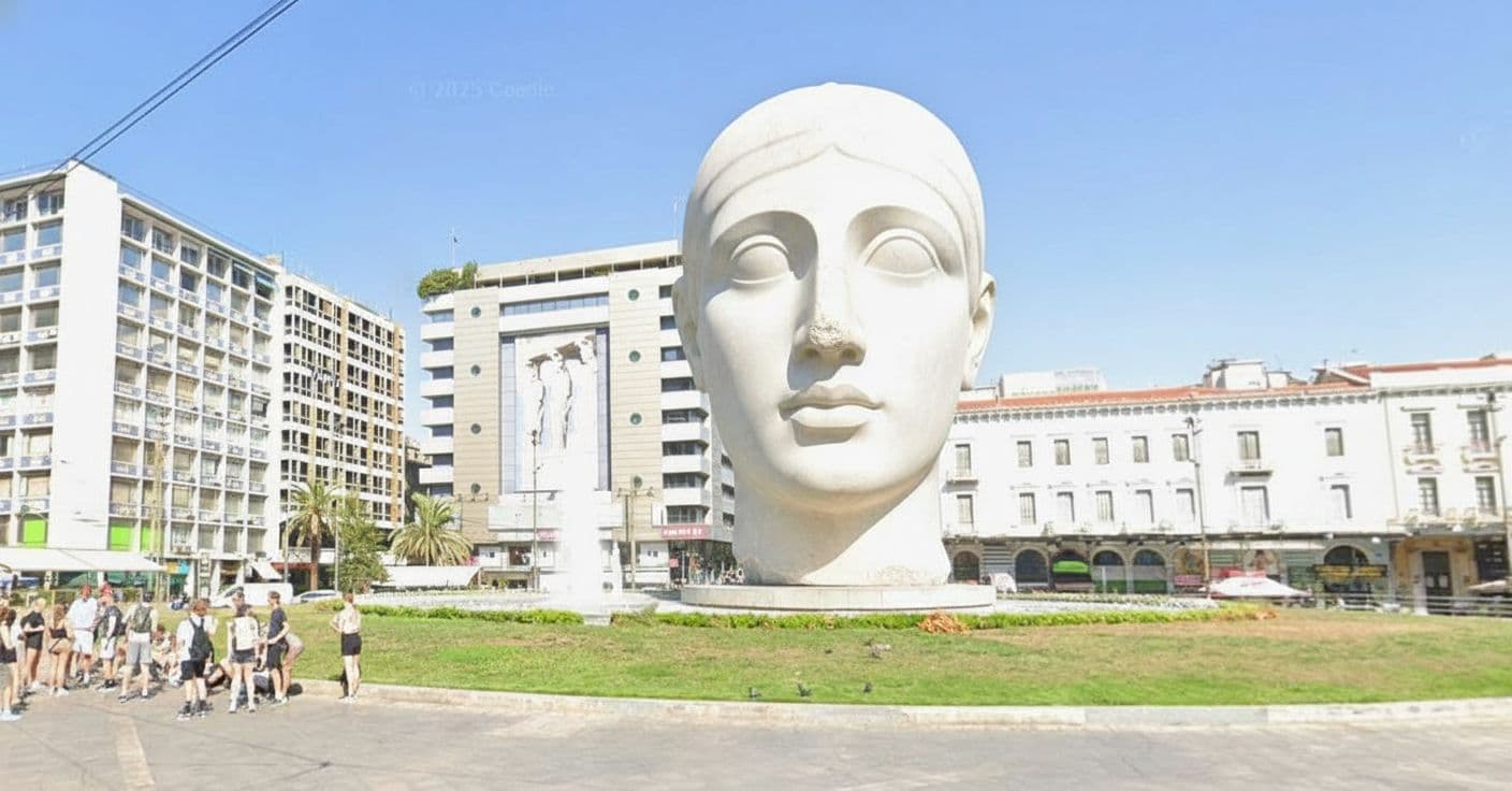 AI generated: Put in the centre of the square a giant cycladic marble head.