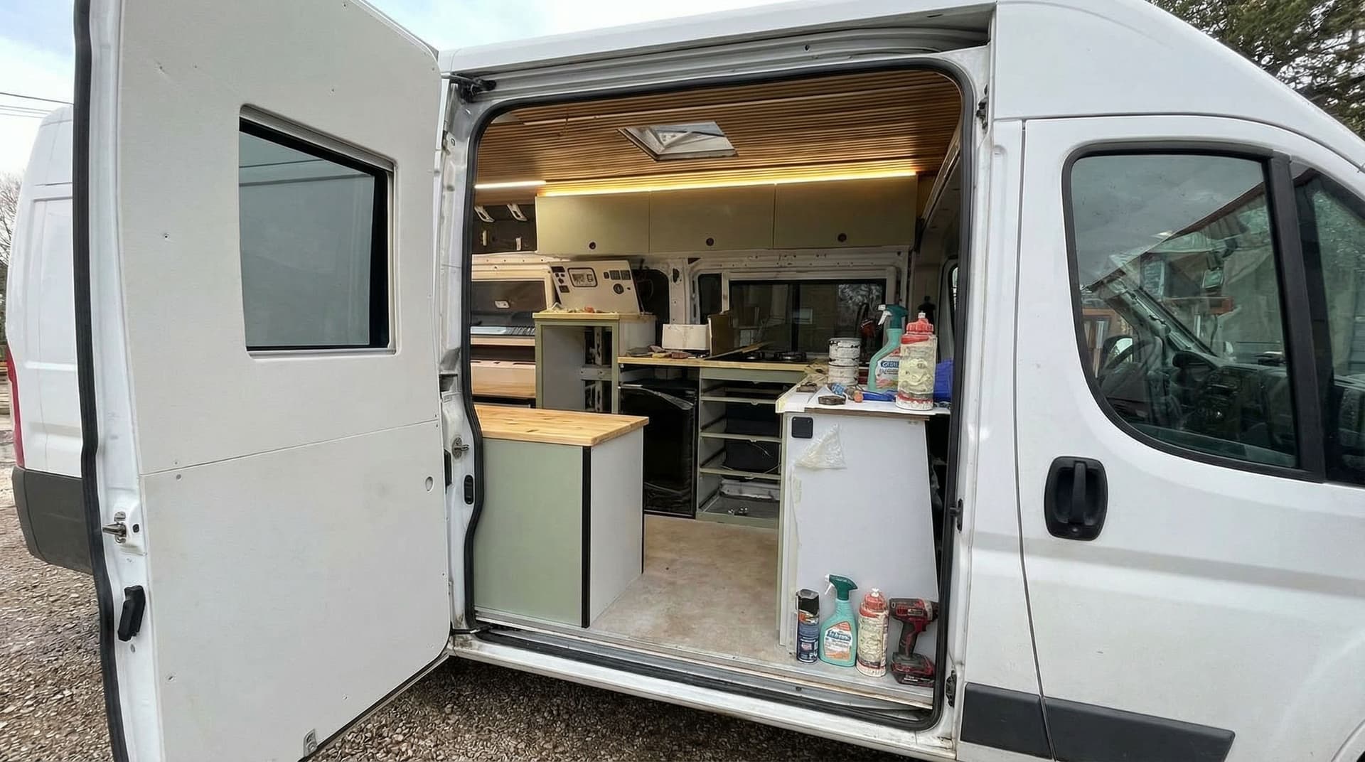 AI generated: Generate a close up image from the outside of the side door, showcasing the interior of the van as i...