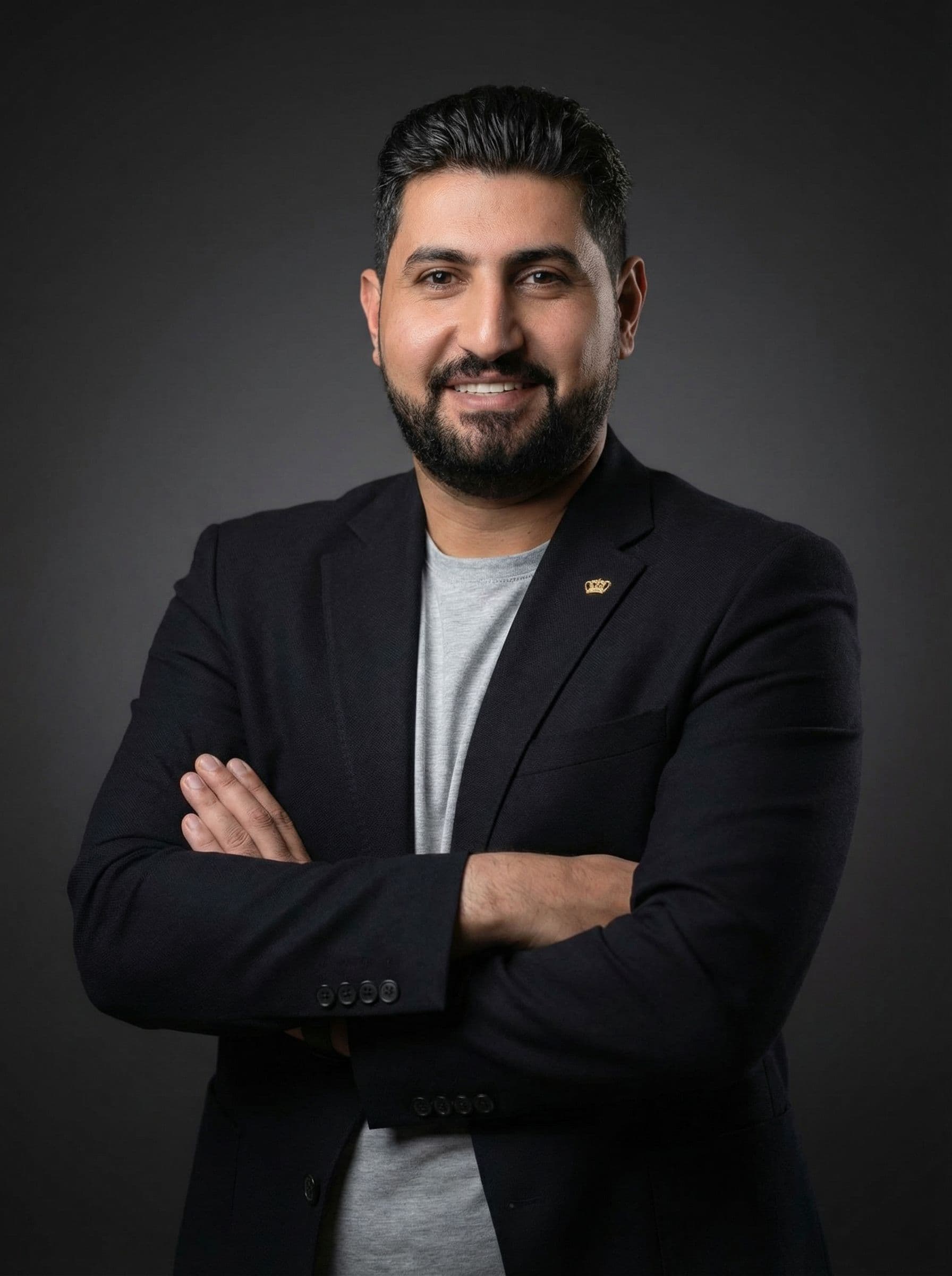 AI generated: Businessman standing, arms crossed, warm confident simple smile, black blazer over light top, dark n...