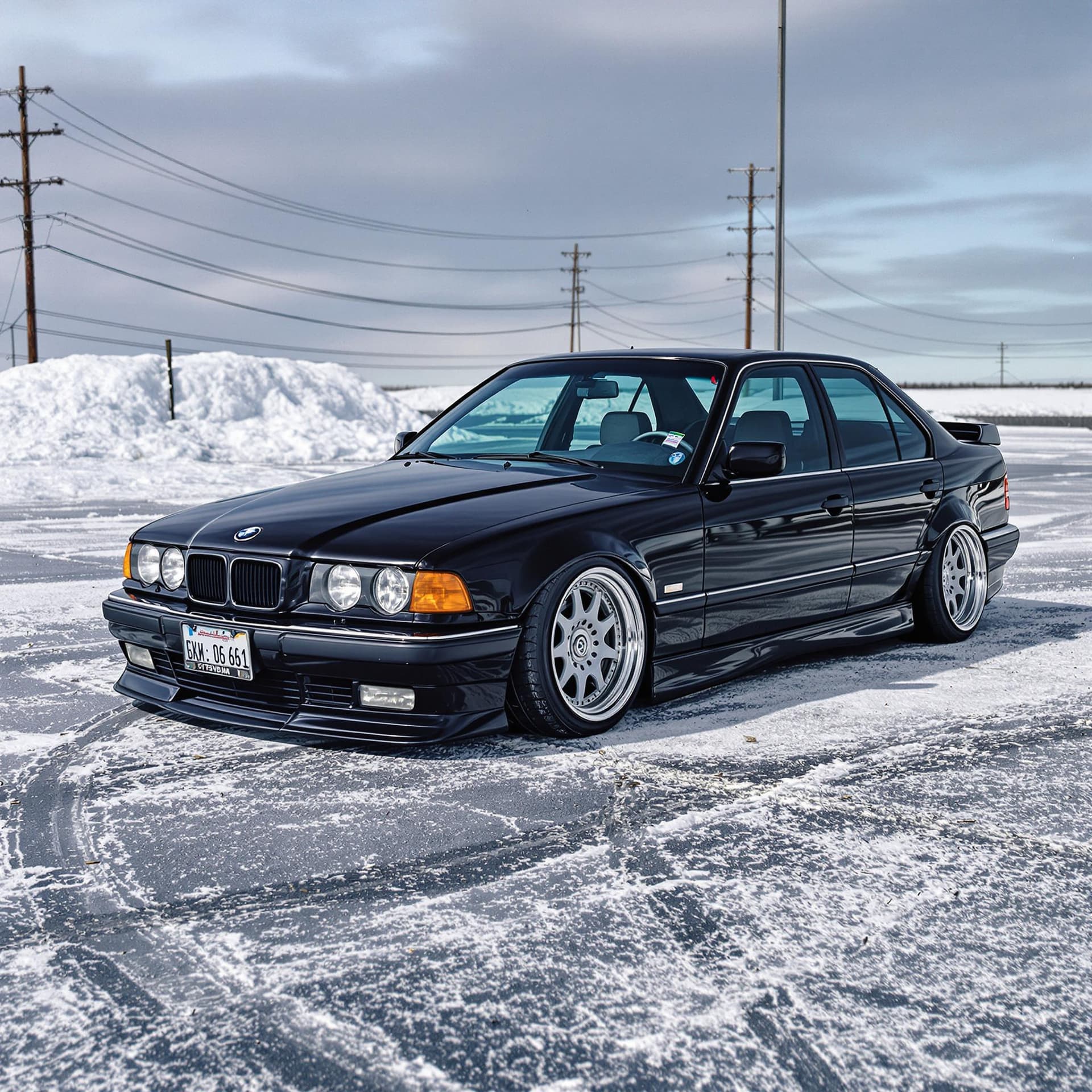 AI generated: black stance e38 parked in icy parking lot