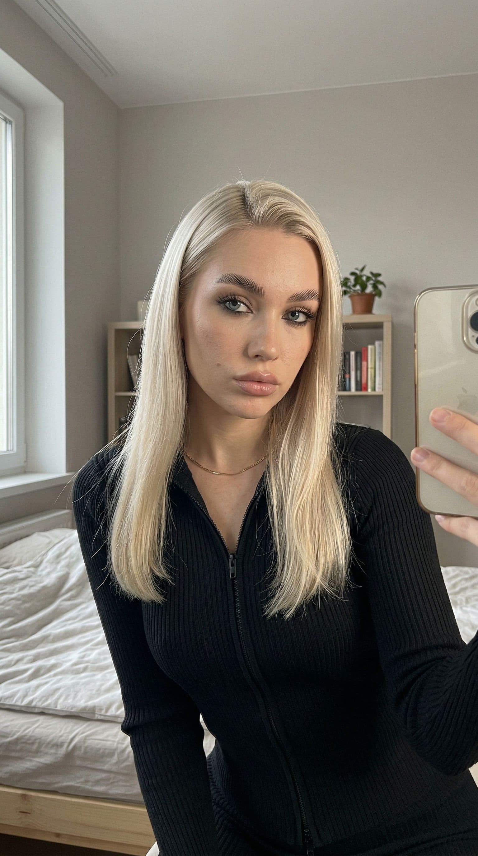 AI generated: Candid iPhone front camera selfie of a young adult European-looking woman indoors.
Arm’s-length self...