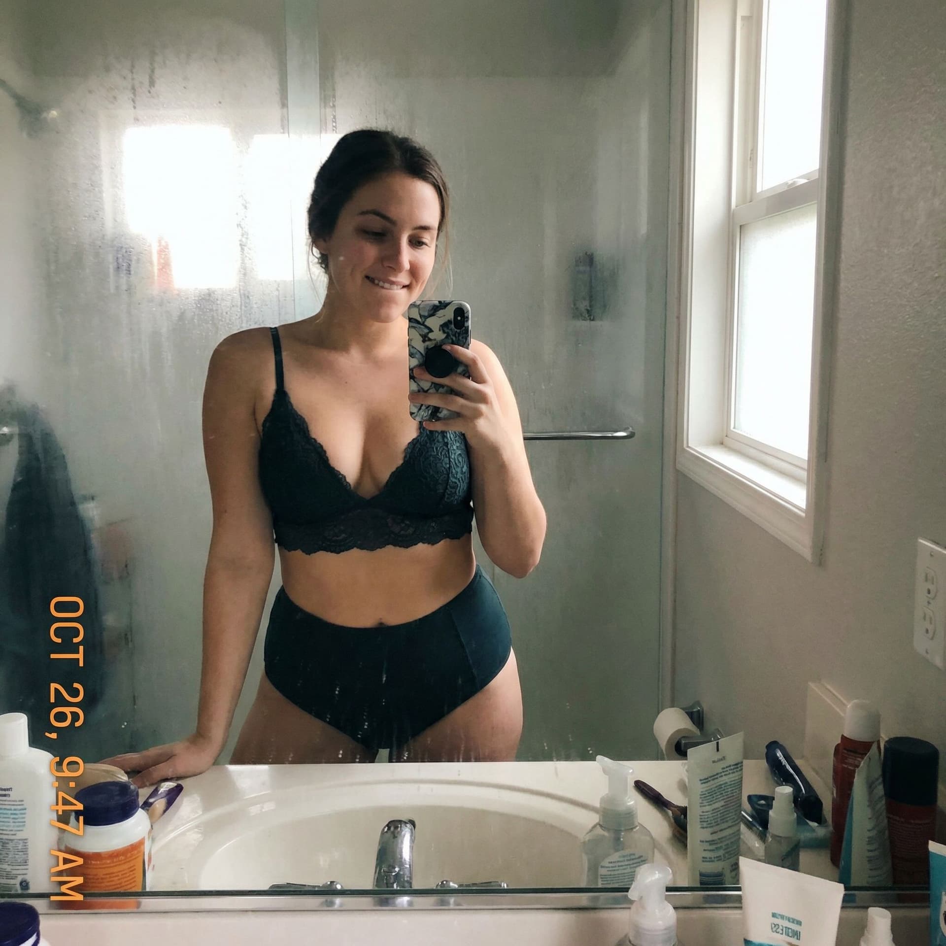 AI generated: Casual mirror selfie in a bathroom, smartphone photo quality. busty adult with a playful expression,...