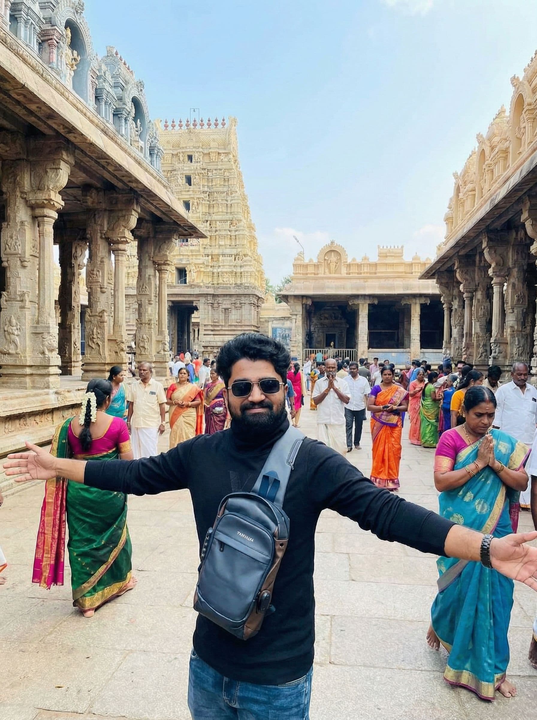 AI generated: replace background to an indian temple setup and add other people in background with same lighting 