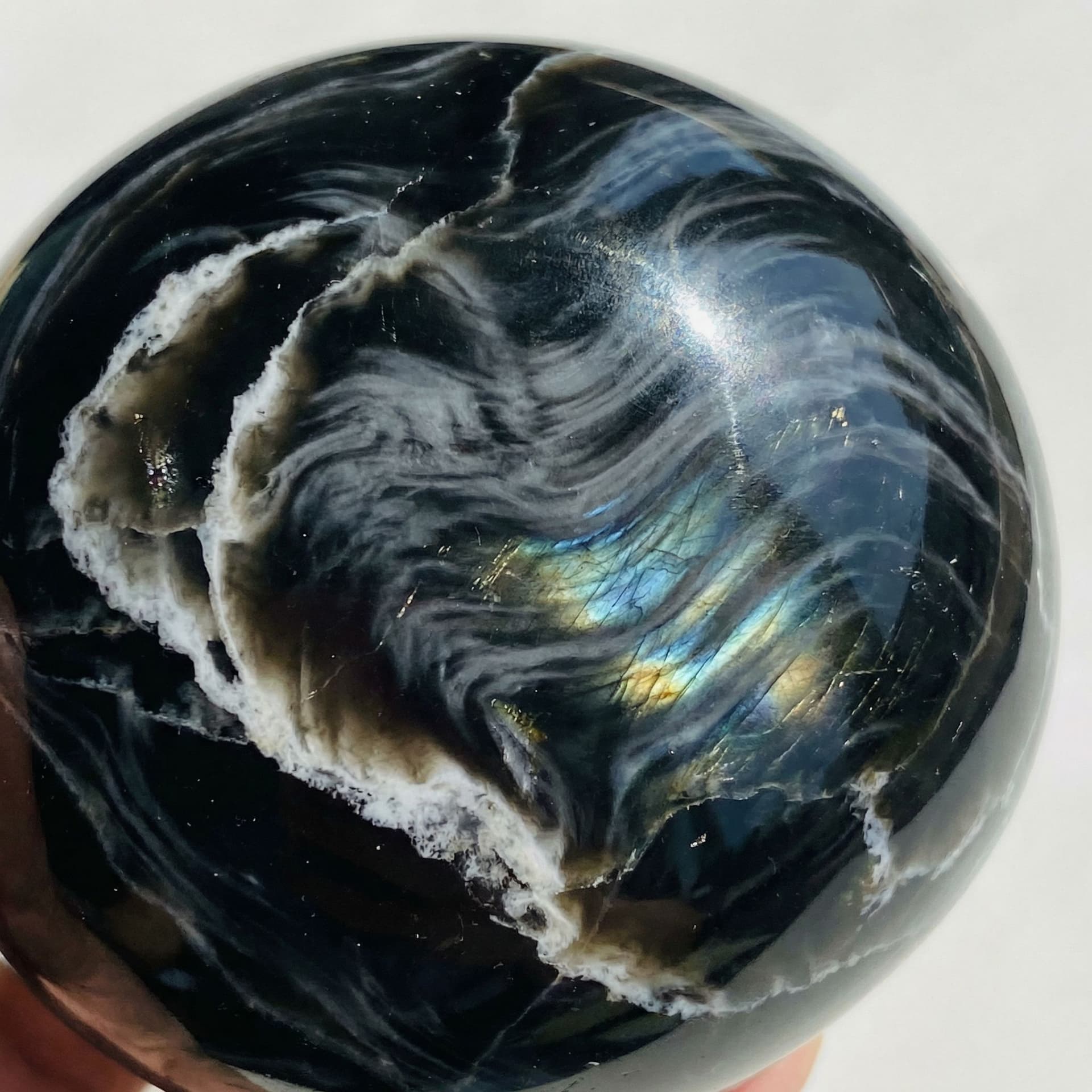 AI generated: Black obsidian with white veins flowing through it like wind and grey whips also flowing through it ...
