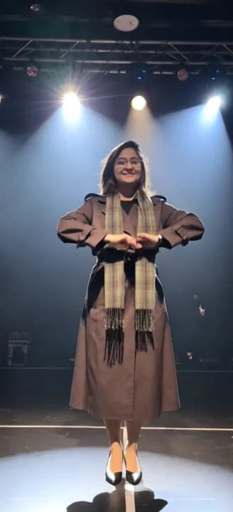 AI generated video: Final bow, thunderous applause. Eyes sparkling with joy, she offers elegant curtsy, costume catching...