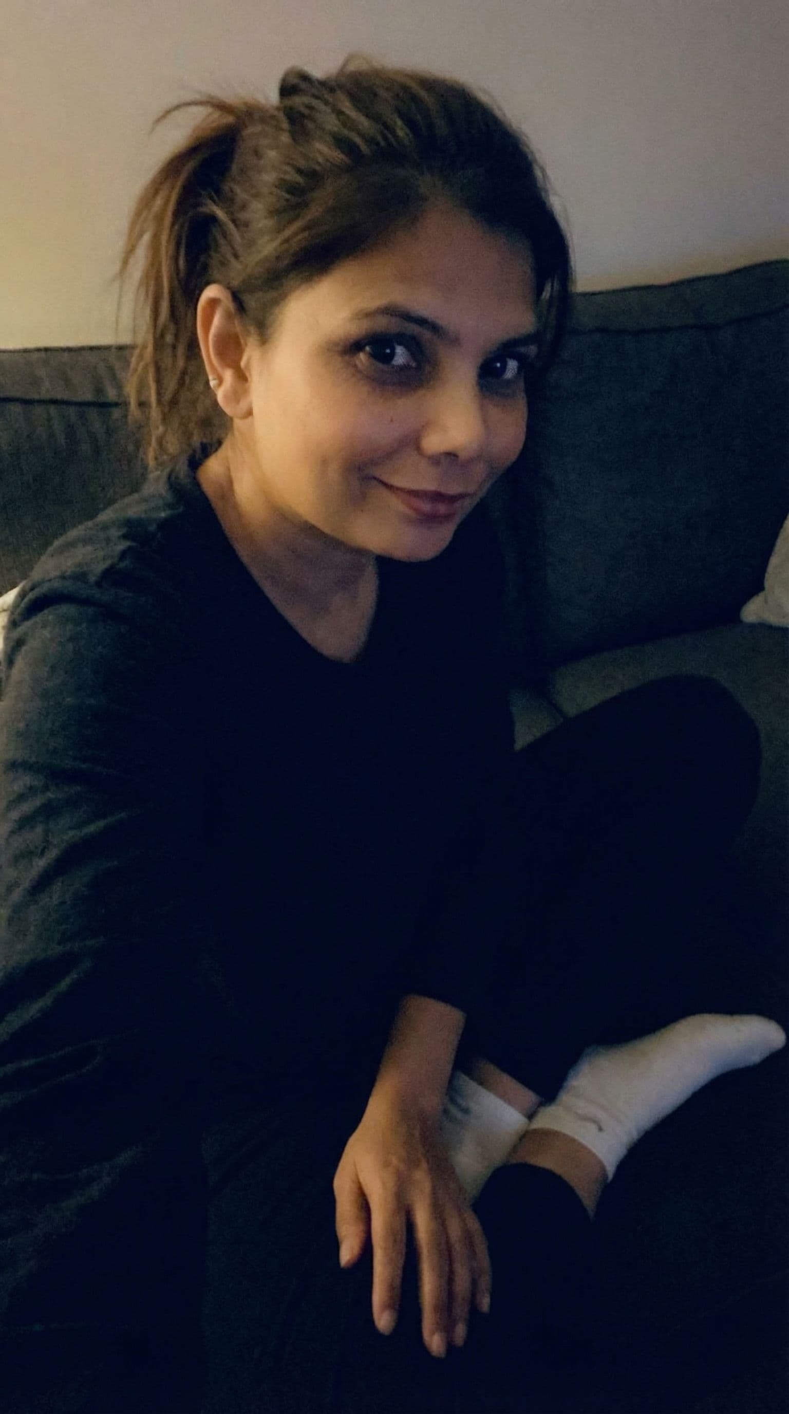 AI generated: Romantic selfie looking at me,a sloppy snapshot. Sitting on a couch at night teasing(no lights), hom...