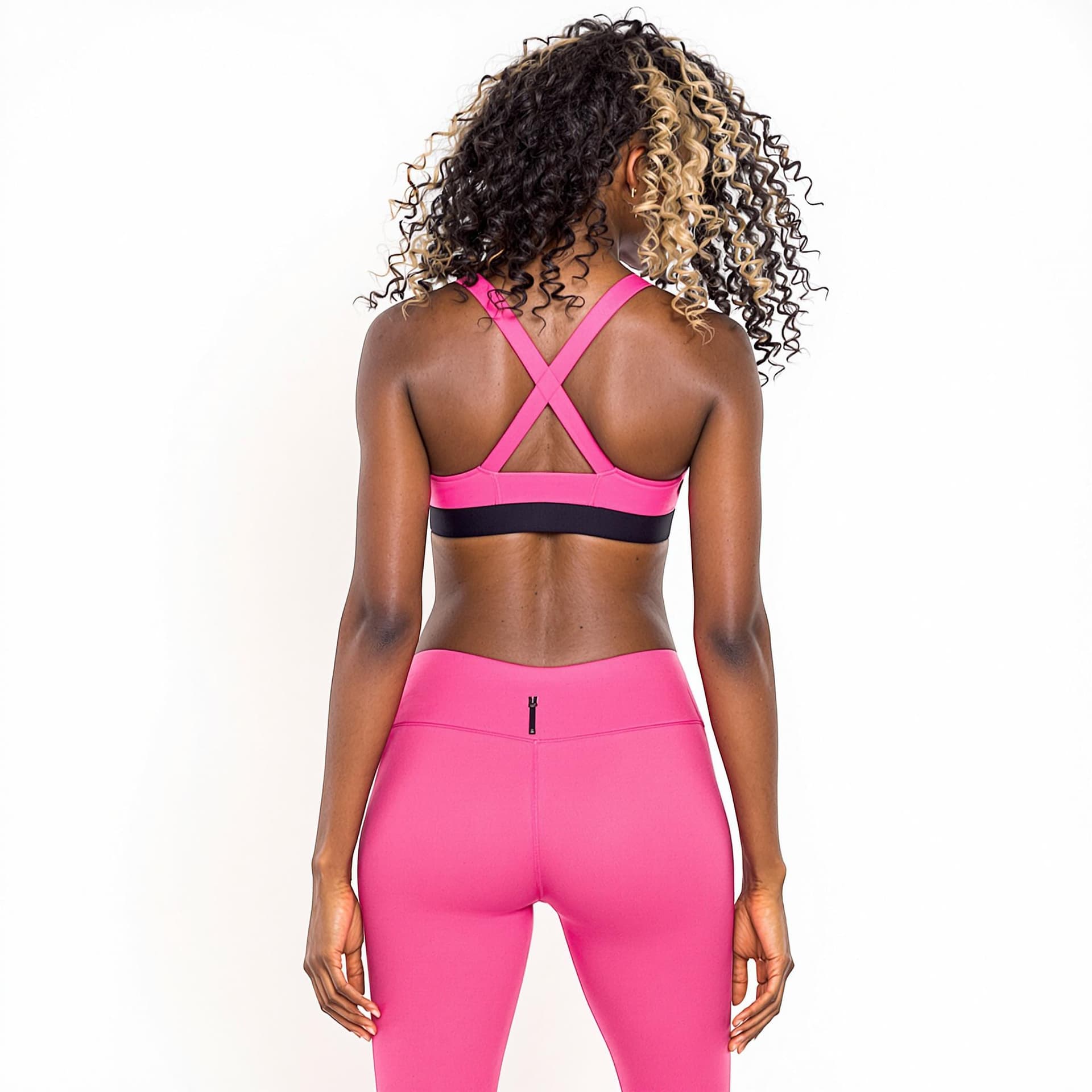 AI generated: a black woman wearing pink sports bra and matching leggings. The backdrop is white.