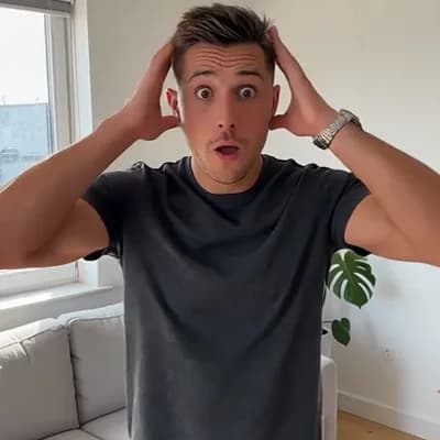 AI generated video: A man grabs his head with his hands and feigns horror.