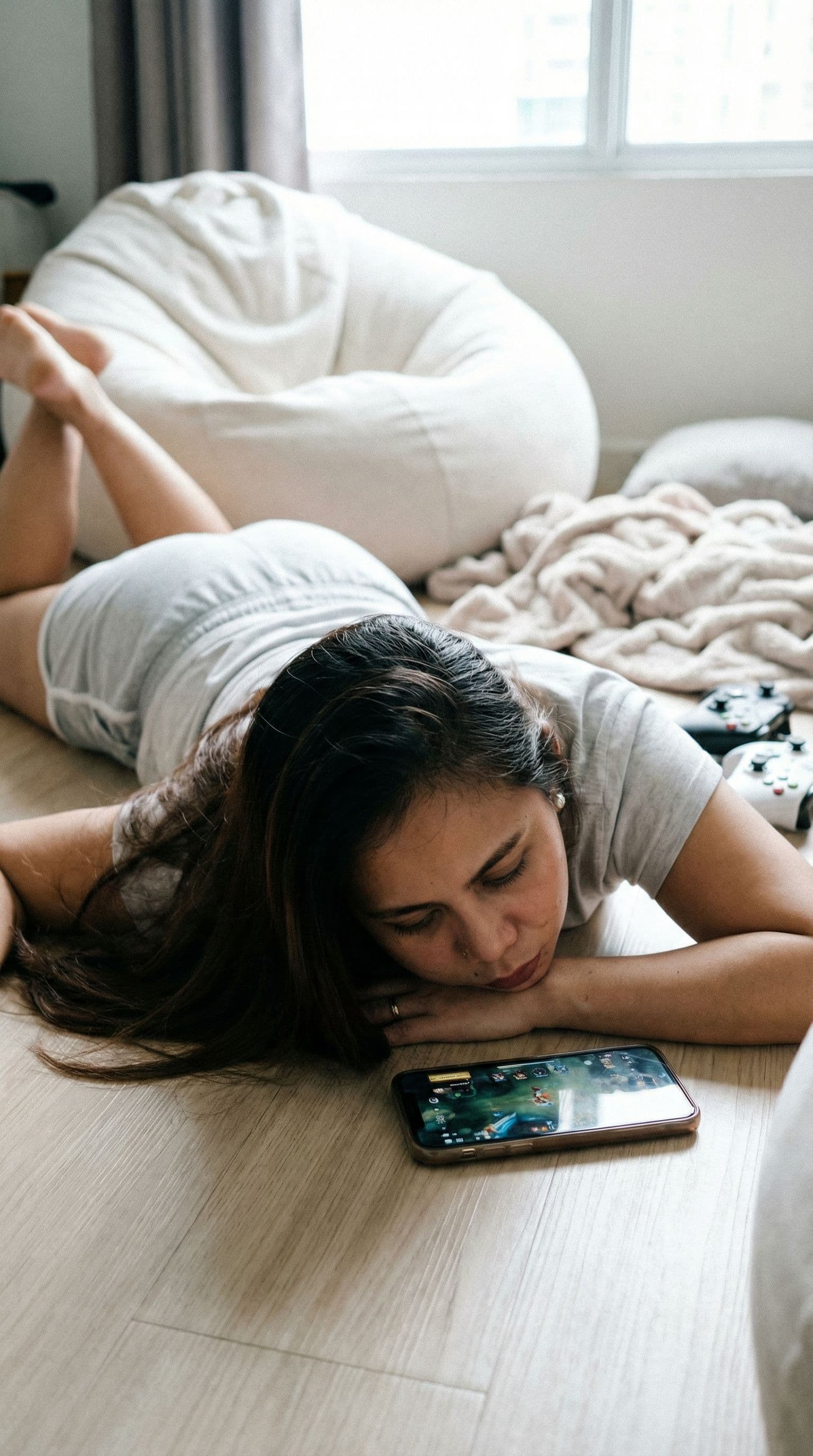 AI generated: A bright lit, cozy bedroom scene at day, featuring a young person with long dark hair lying sprawled...
