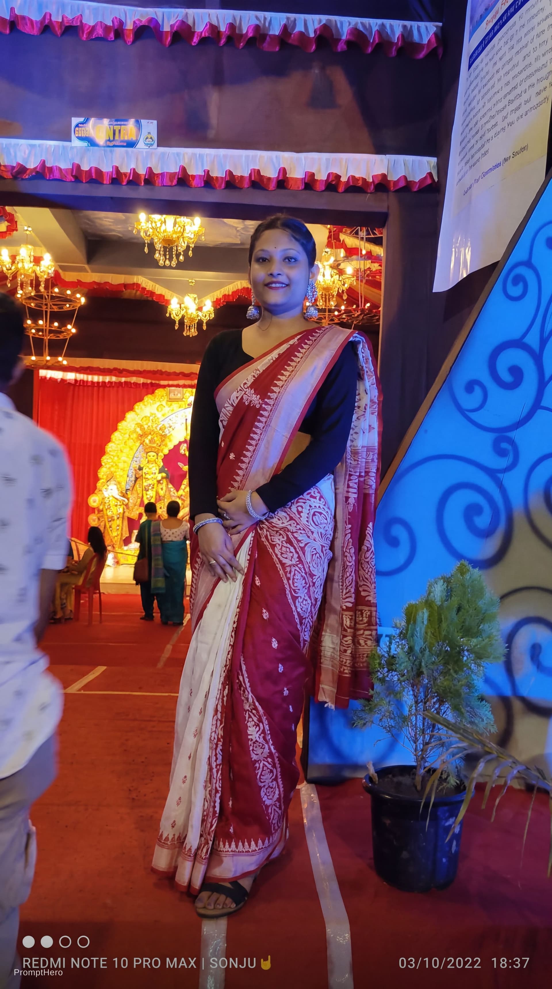 AI generated: Replace the woman's saree colour into red with white mix colour but don't cover her navel same like ...