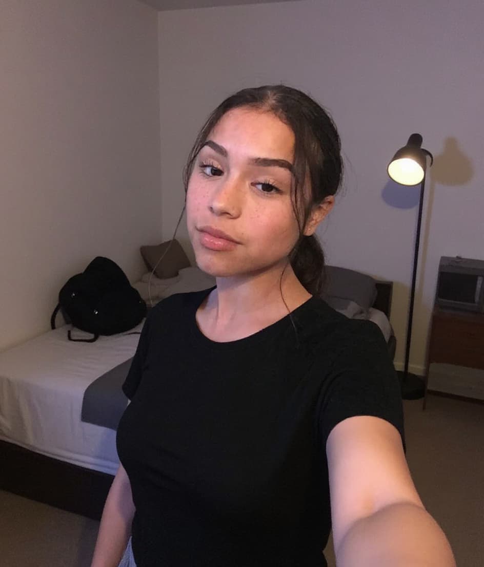 AI generated: Beautiful Latina woman taking a selfie in her bedroom mirror, she is showing her feet by lifting the...