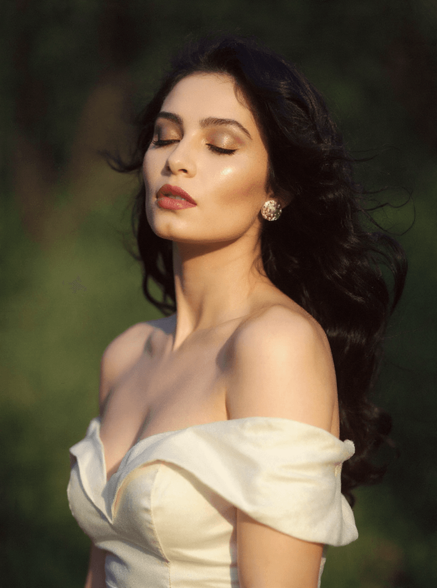 AI generated: A half Body Photo of a beautiful dark haired girl, feeling the wind and sun on her face, her eyes ar...