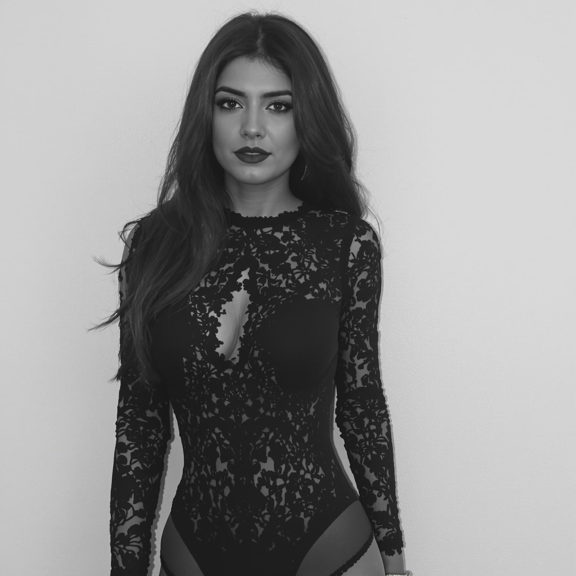 AI generated: Captured in a black and white shot, a woman with long dark hair is wearing a black lace bodysuit. Th...