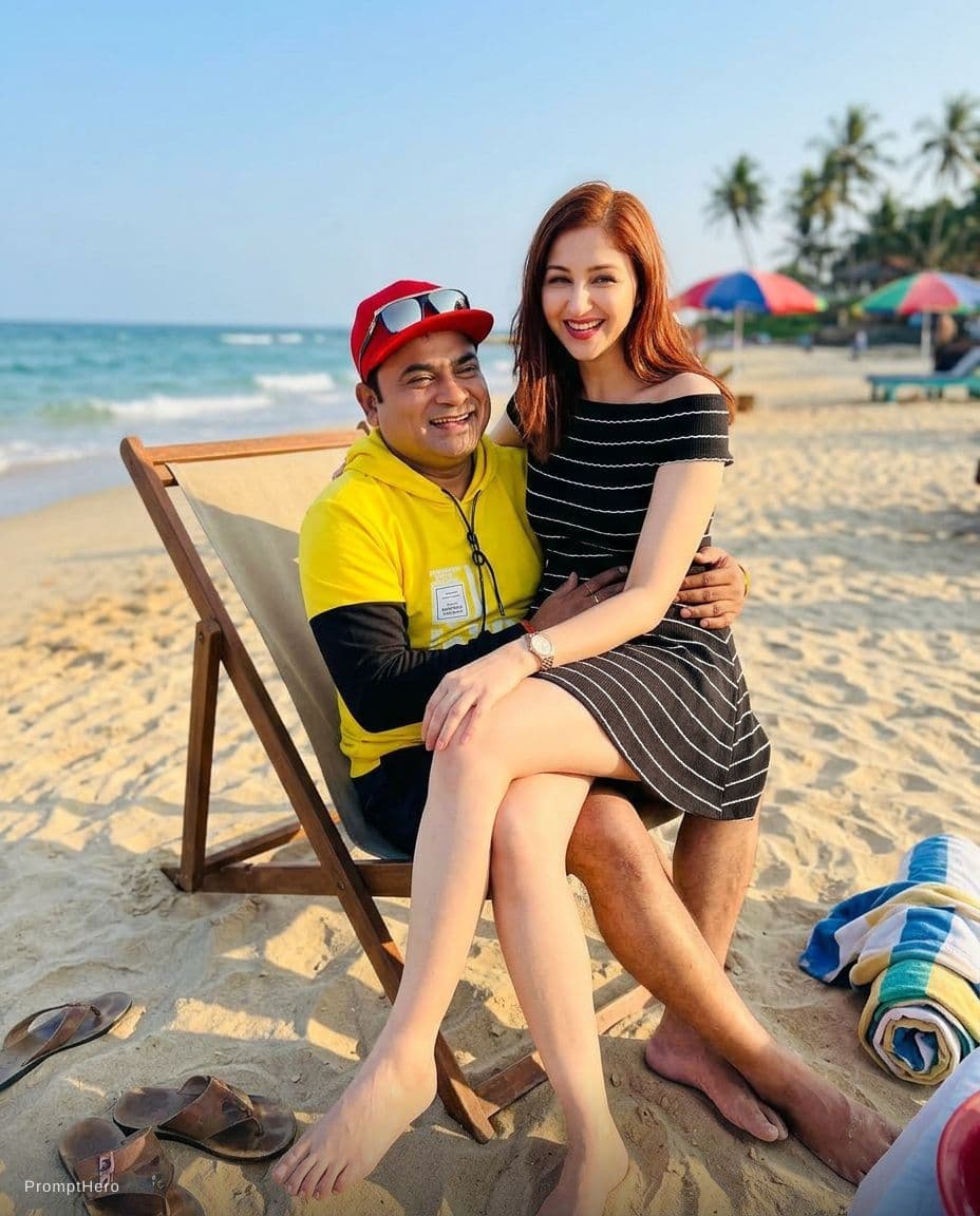 AI generated: Make them at a beach sitting in a single chair with the girl sitting on the boys lap