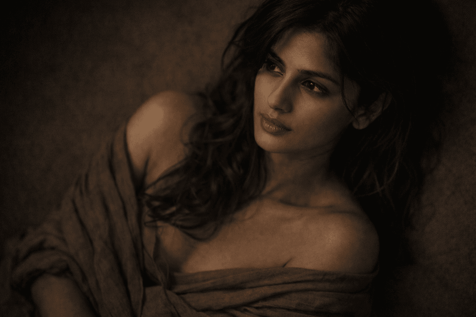 AI generated: Cinematic sensual portrait of an Indian woman, quiet intimate mood, soft low-key lighting grazing th...