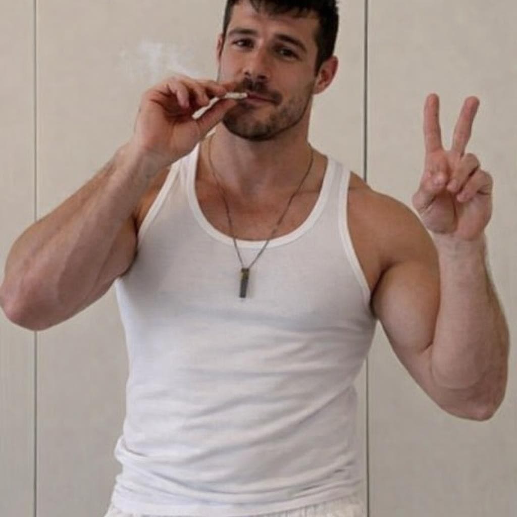 AI generated: make this man wearing a white tank top and white short shorts smoking a joint and holding up the pea...
