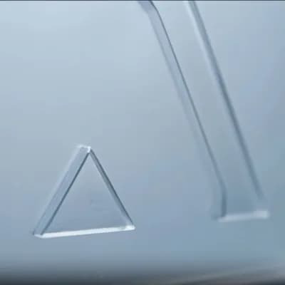 AI generated video: Make the glassy logo render disappear slowly, fading out until it fully disappears, leaving only the...