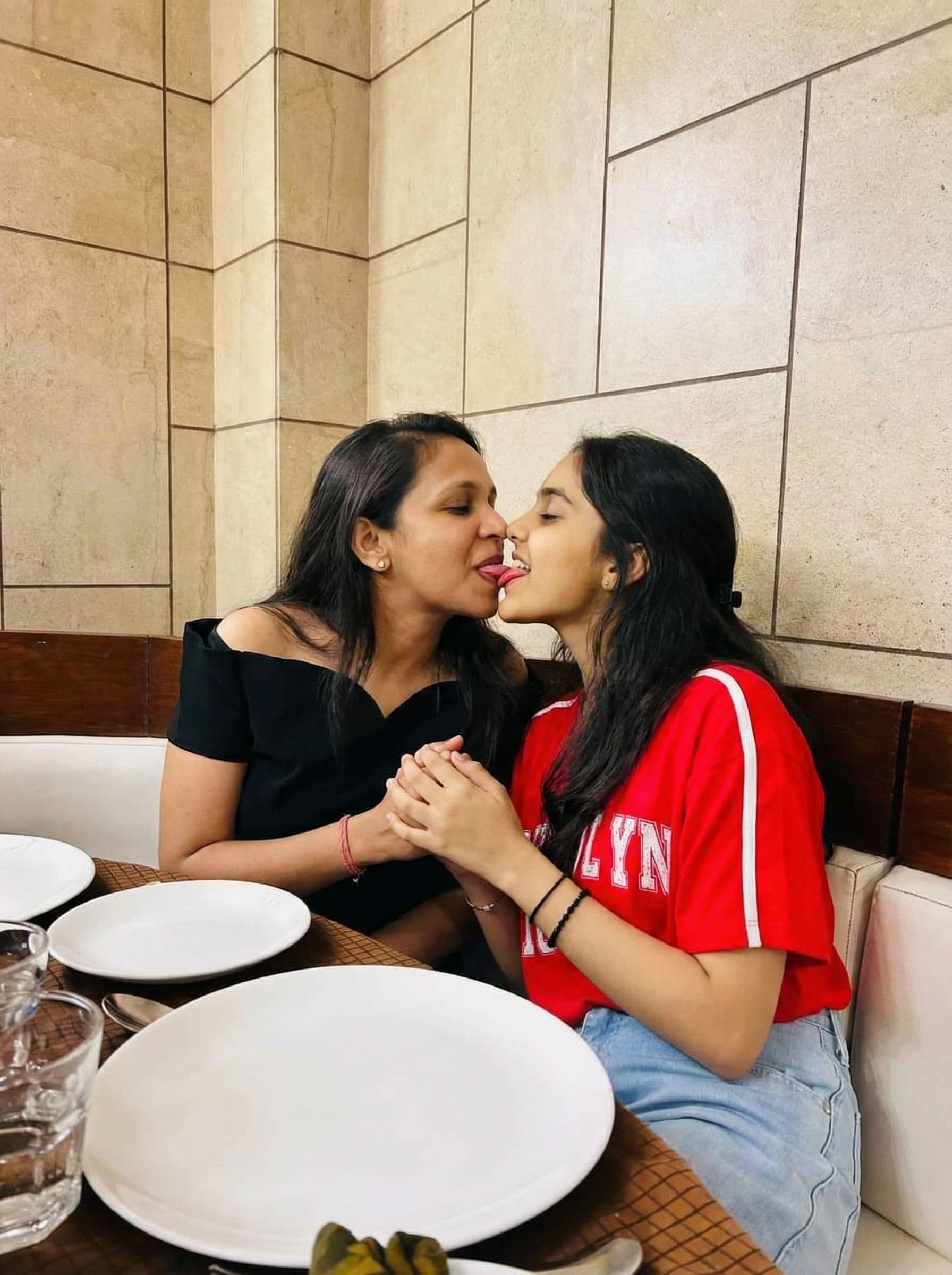 AI generated: two girls passionately kissing with tongue