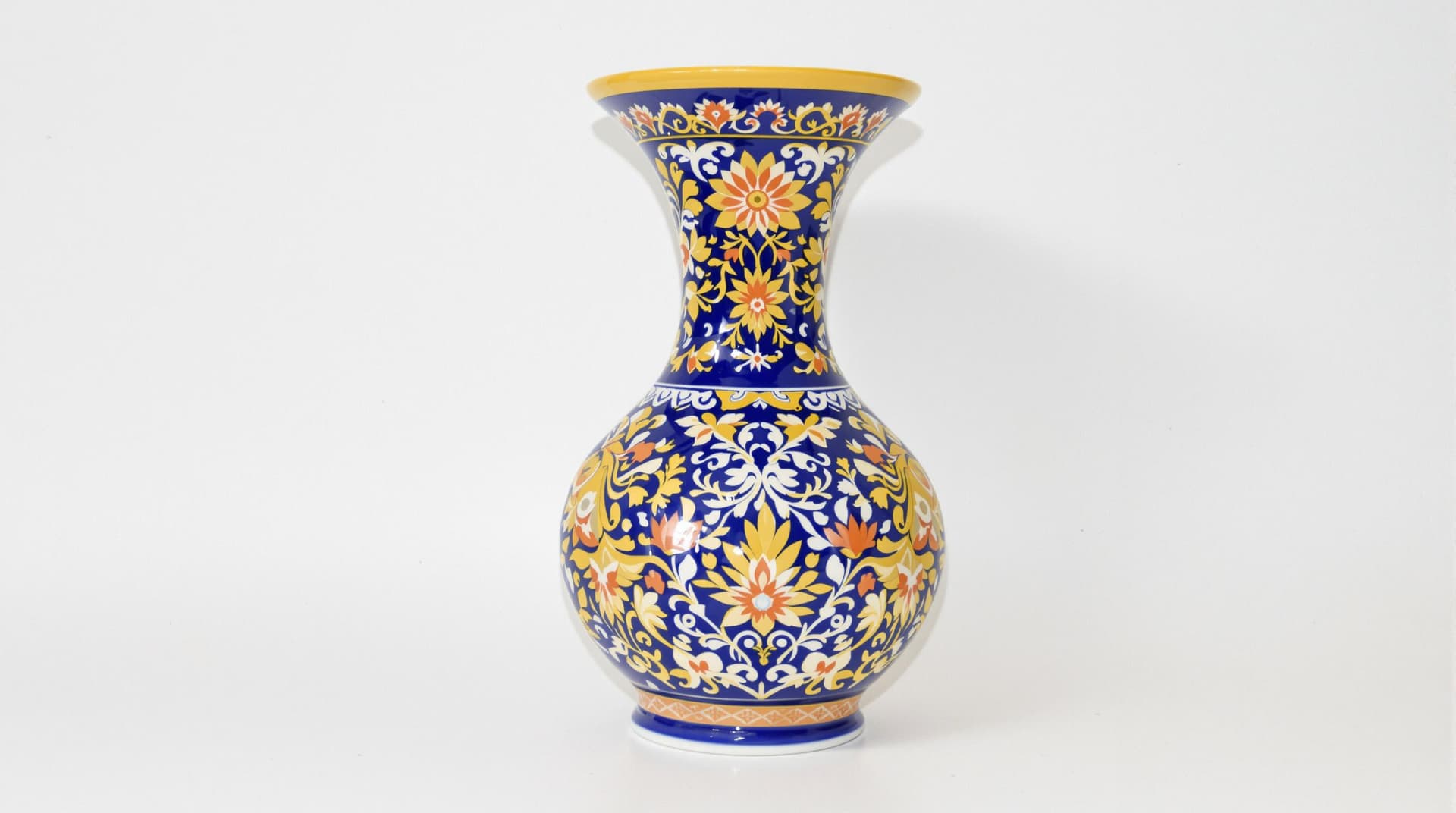 AI generated: Photograph of a decorative vase with a wide, flared base and a narrow, flared neck, featuring intric...