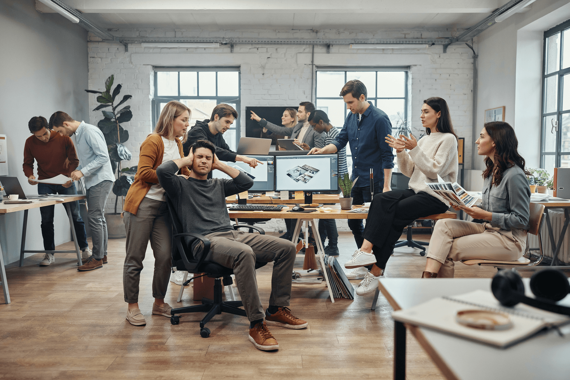 AI generated: A hyper-realistic modern creative agency office during a deadline. One experienced designer sits at ...