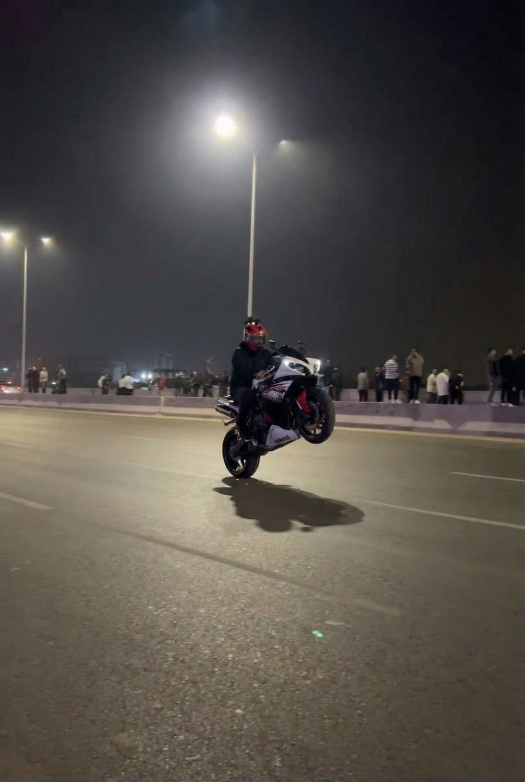 AI generated: Added the bike in this road wheelie 