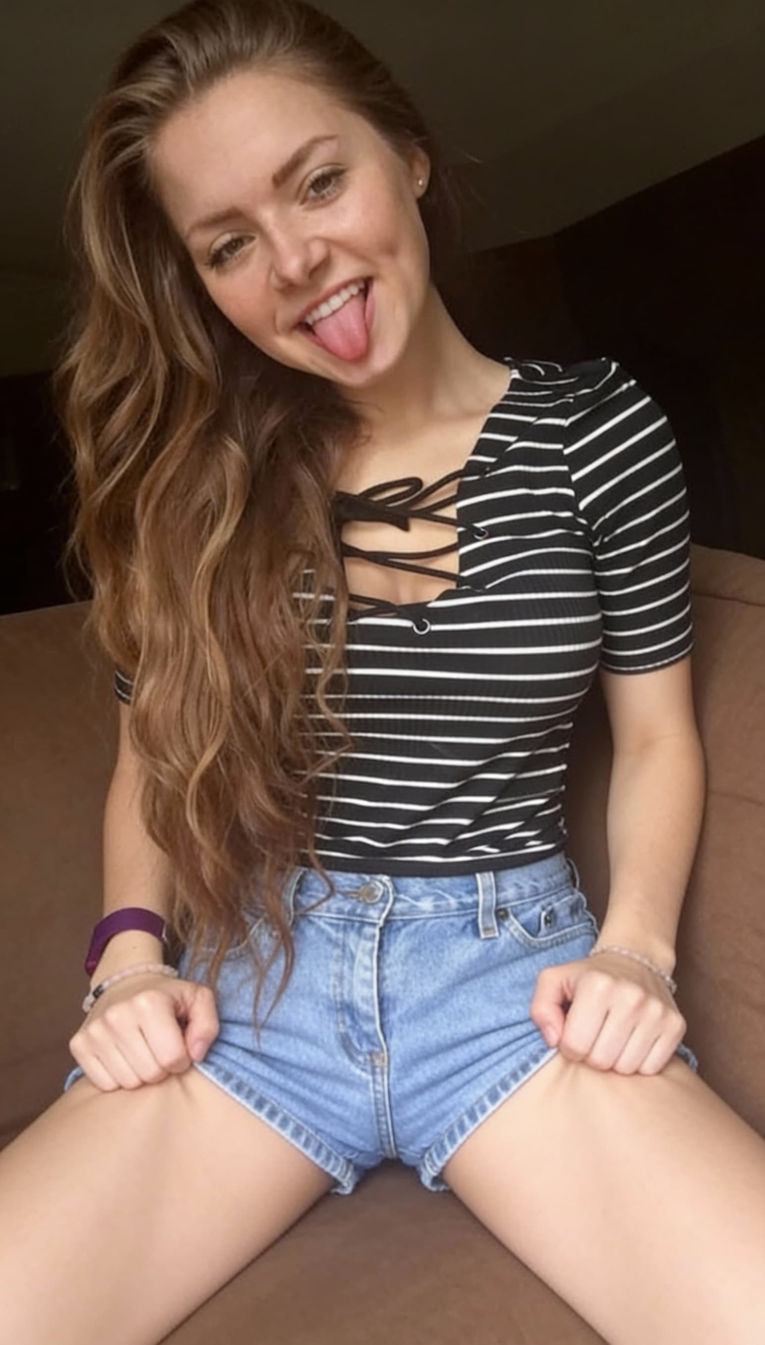 AI generated: hands squeezing backside above the legs, remove hand holding phone, stick tongue out