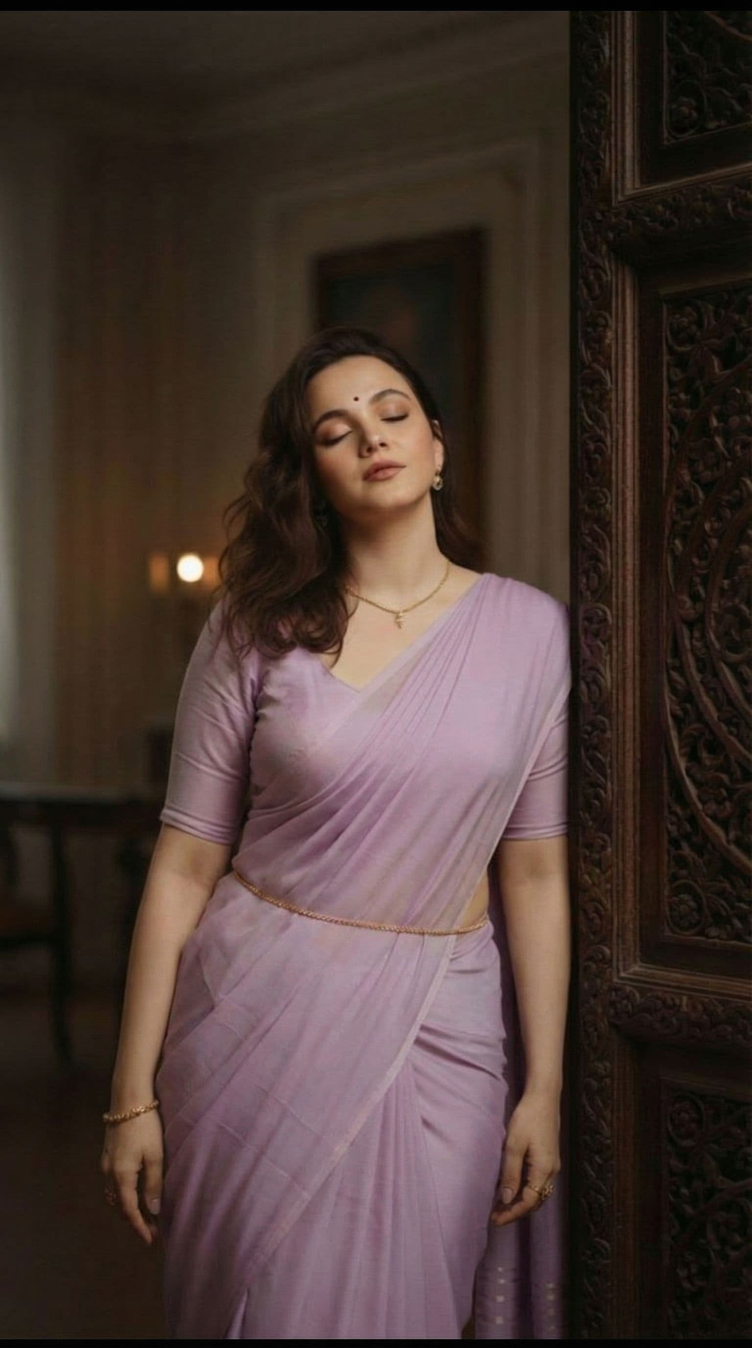 AI generated: Change the outfit as per the promt 
Outfit & Styling
She is wearing a soft lavender traditional sare...