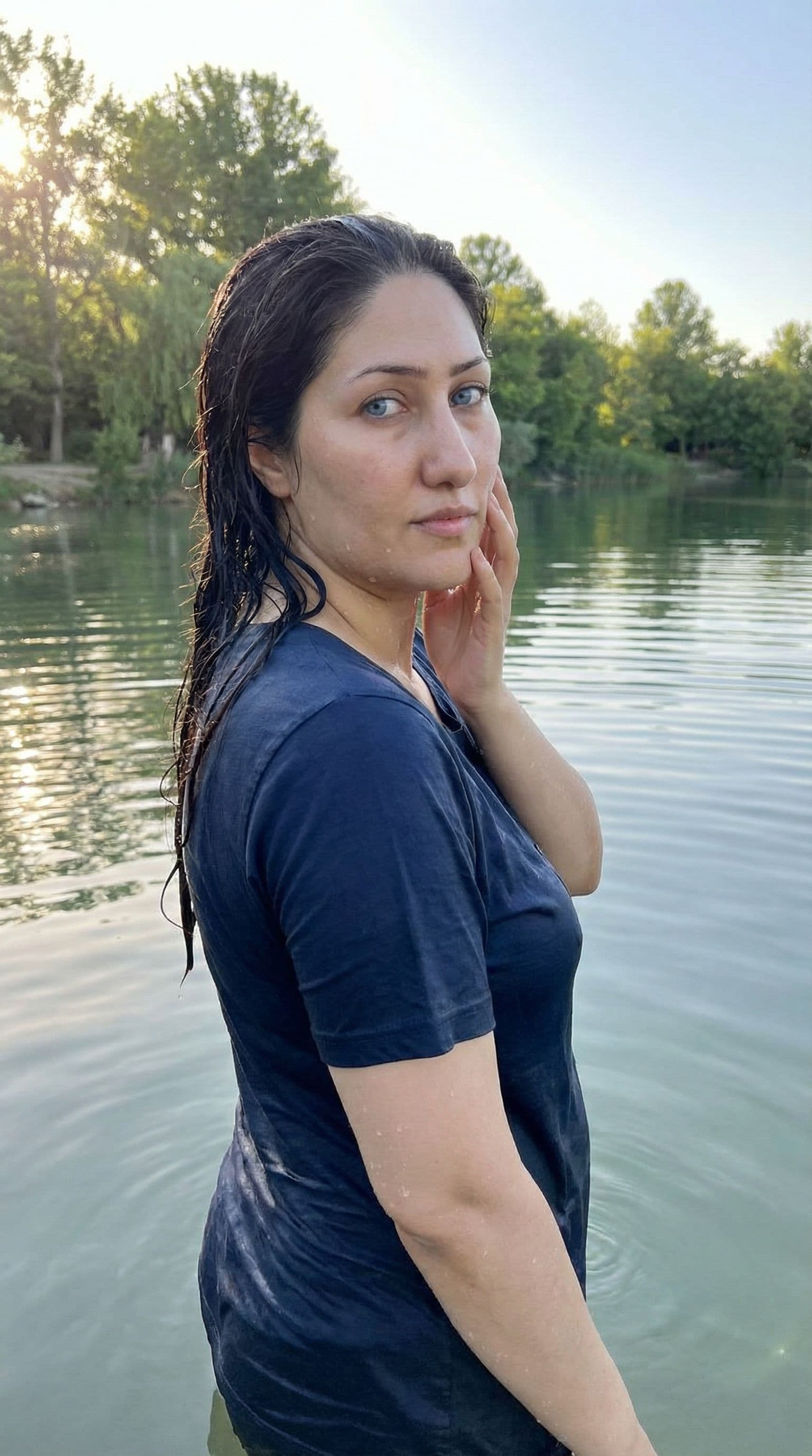 AI generated: The uploaded woman stands in a serene lake, her back to the viewer, looking over her shoulder with l...