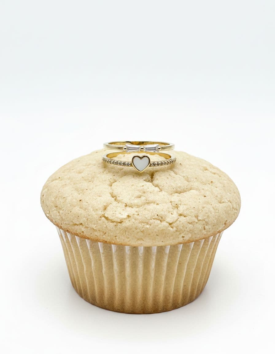 AI generated: “Place the uploaded ring on top of a simple, raw (unbaked) cupcake with plain texture. The cupcake s...