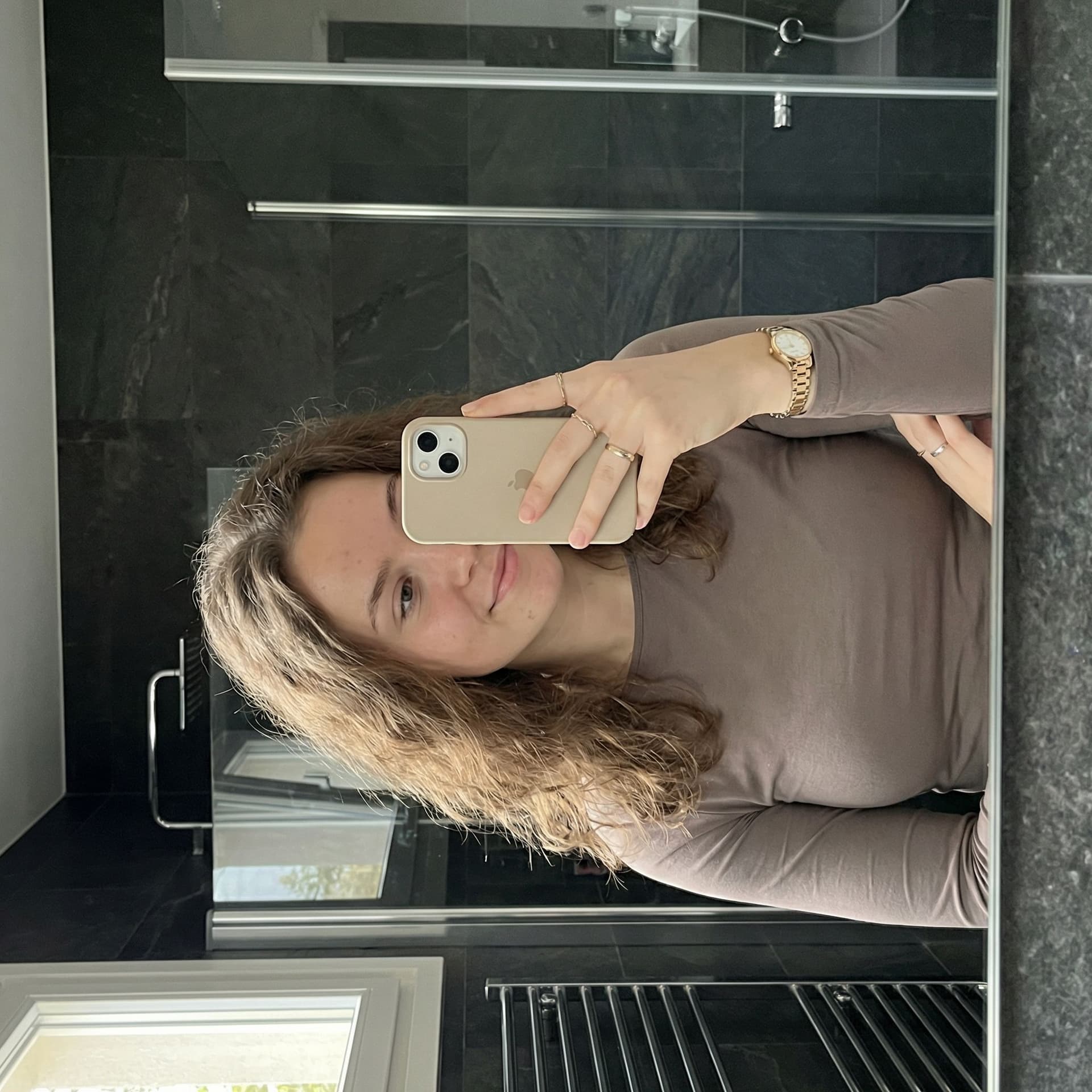 AI generated: Create an ultra-photorealistic horizontal (landscape) mirror selfie of a young adult woman (mid-20s)...