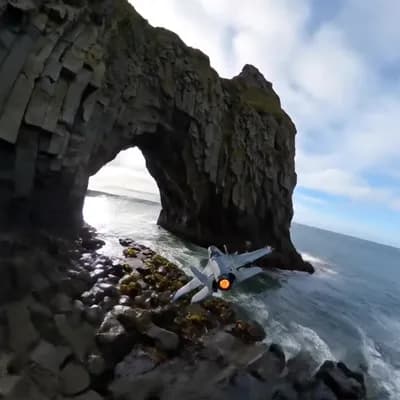 AI generated video: Camera slashes across jagged headlands at mast height, then snap-rolls into a helical dive through a...