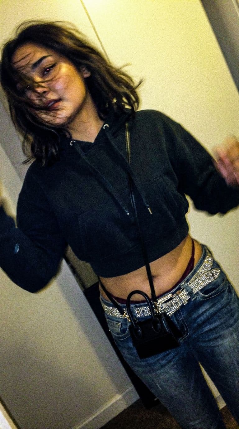 AI generated: a lo-fi 2015s-era, diagonally taken, low-quality iPhone photo of a 20-year-old baddie. The shot is i...