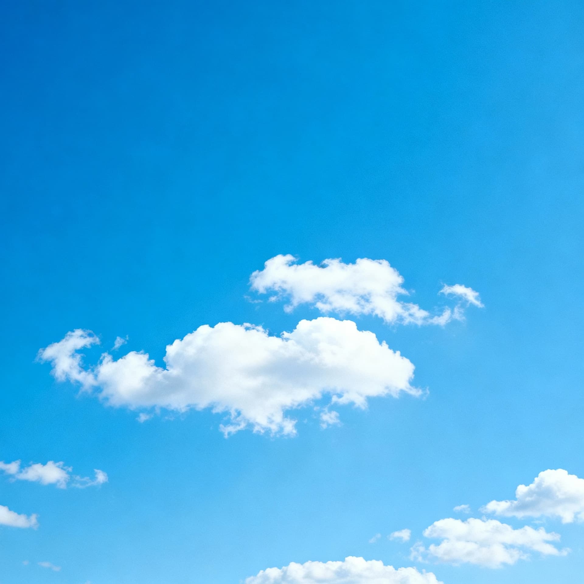 AI generated: High-resolution background of a clear blue sky with soft, fluffy white clouds scattered naturally. B...