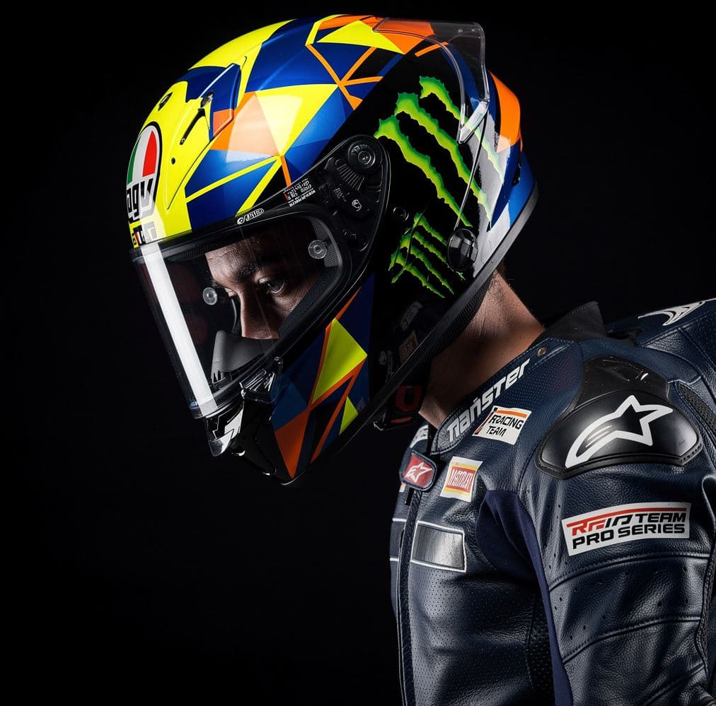 AI generated: A hyper-realistic close-up photograph of a professional motorcycle racer in profile, head bowed slig...