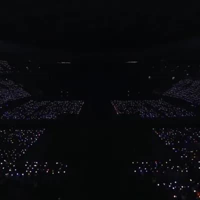 AI generated video: This 15-second epic K-pop concert sequence  starts with an 8K wide crane shot of a massive, dark are...
