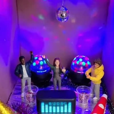 AI generated video: Inside the cardboard box, there is a party with lights and music.